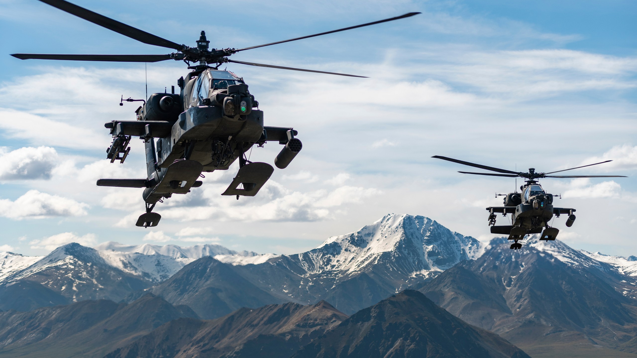 In this photo released by the U.S. Army, AH-64D Apache Longbow attack helicopters from the 1st Attack Battalion, 25th Aviation Regiment, fly over a mountain range near Fort Wainwright, Alaska, on June 3, 2019. The U.S. Army says two Army helicopters similar to the ones in this picture crashed Thursday, April 27, 2023, near Healy, Alaska, killing three soldiers and injuring a fourth. The helicopters were returning from a training flight to Fort Wainwright, based near Fairbanks. (Cameron Roxberry/U.S. Army via AP)