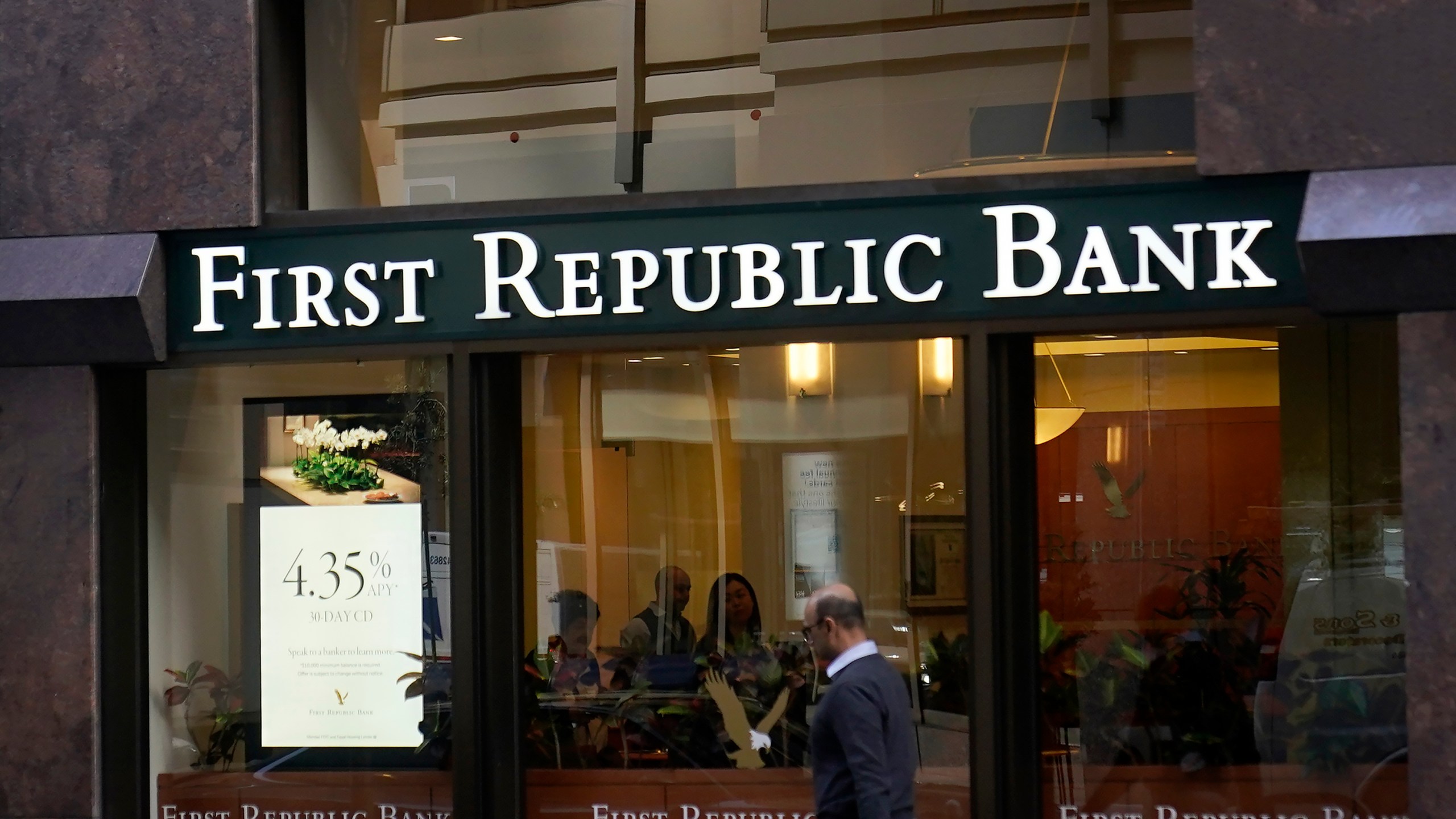 FILE - A pedestrian walks past a First Republic Bank in San Francisco on April 26, 2023. Regulators continued their search for a solution to First Republic Bank’s woes over the weekend before stock markets were set to open Monday, May 1. (AP Photo/Jeff Chiu, File)