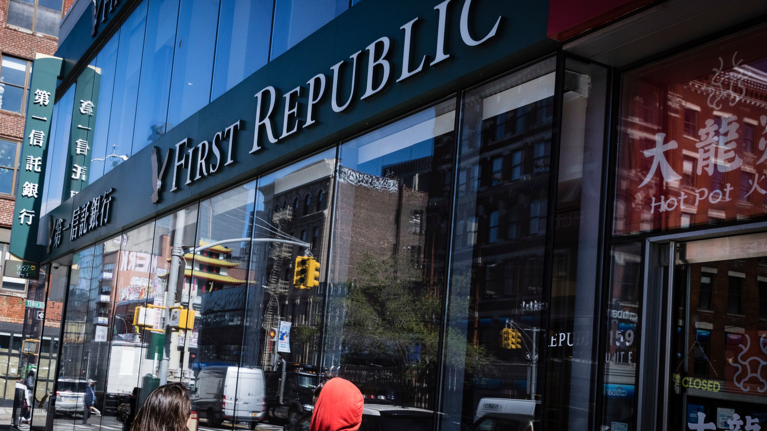 People walk past a First Republic Bank in New York, Monday, May 1, 2023. Regulators seized the troubled First Republic Bank early Monday, making it the second-largest bank failure in U.S. history, and promptly sold all of its deposits and most of its assets to JPMorgan Chase in a bid to stop further banking turmoil that has dominated the first half of this year. (AP Photo/Stefan Jeremiah)