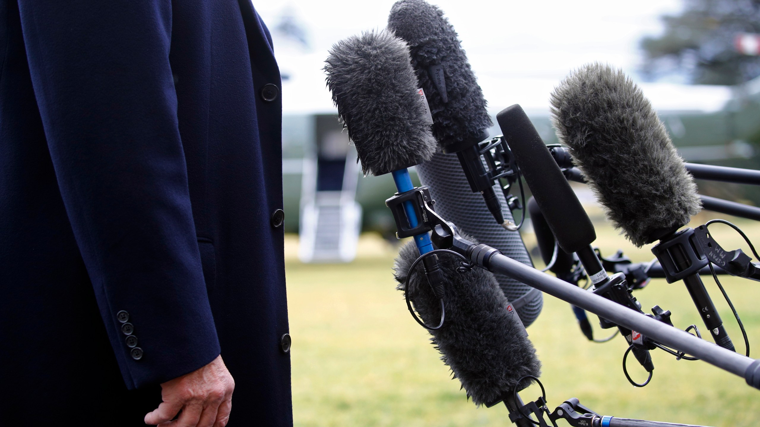 FILE - President Donald Trump stands in front of microphones as he speaks to members of the media on the South Lawn of the White House in Washington, Friday, Feb. 7, 2020, before boarding Marine One. Nearly three-quarters of U.S. adults say the news media is increasing political polarization in this country, and just under half say they have little to no trust in the media's ability to report the news fairly and accurately, according to a new survey from The Associated Press-NORC Center for Public Affairs Research and Robert F. Kennedy Human Rights. (AP Photo/Patrick Semansky, File)