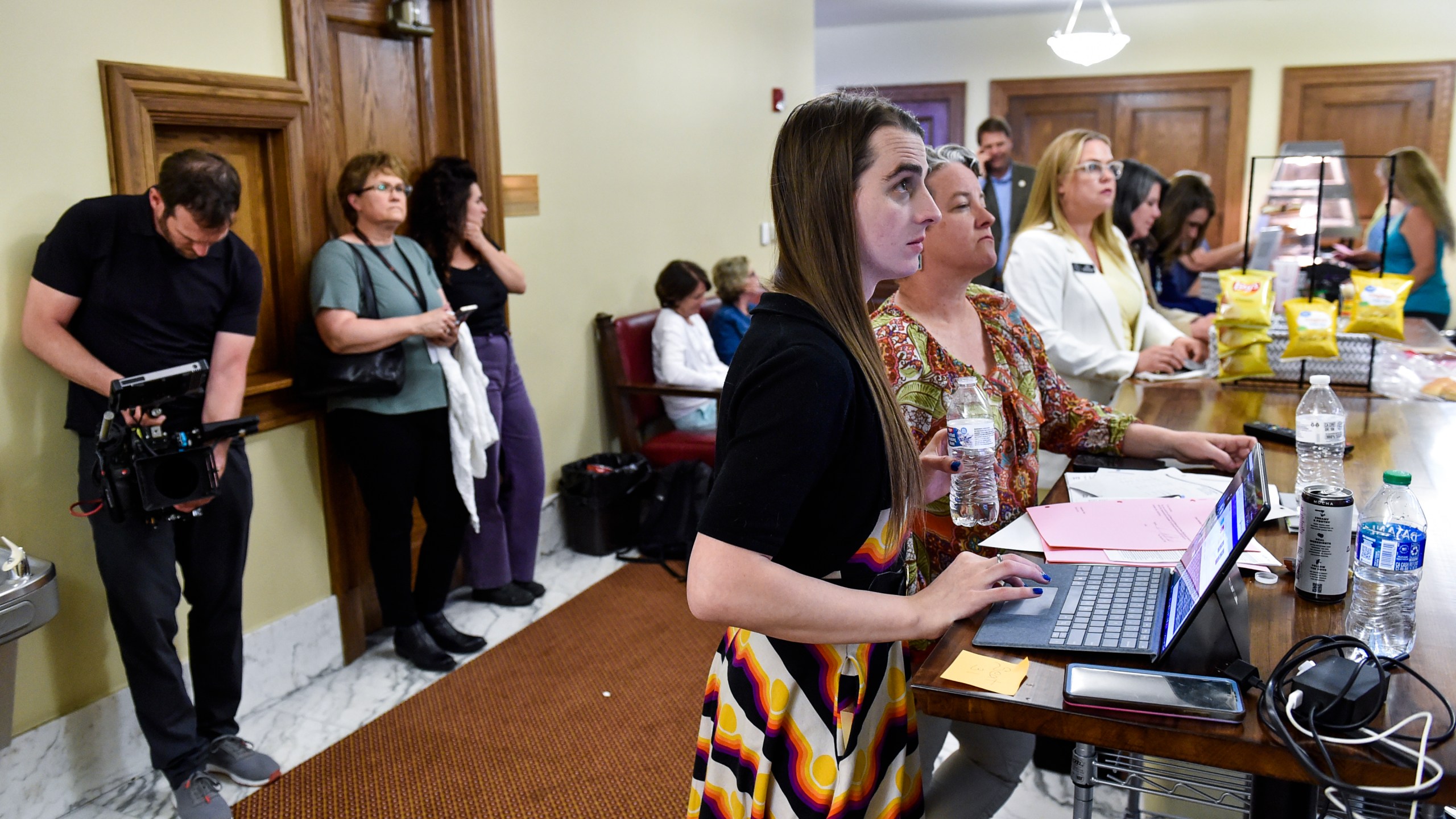 Rep. Zooey Zephyr, D-Missoula, works from the lunch counter outside House of Representatives chamber in the Montana State Capitol in Helena, Mont. on Monday, May 1, 2023. (Thom Bridge/Independent Record via AP)