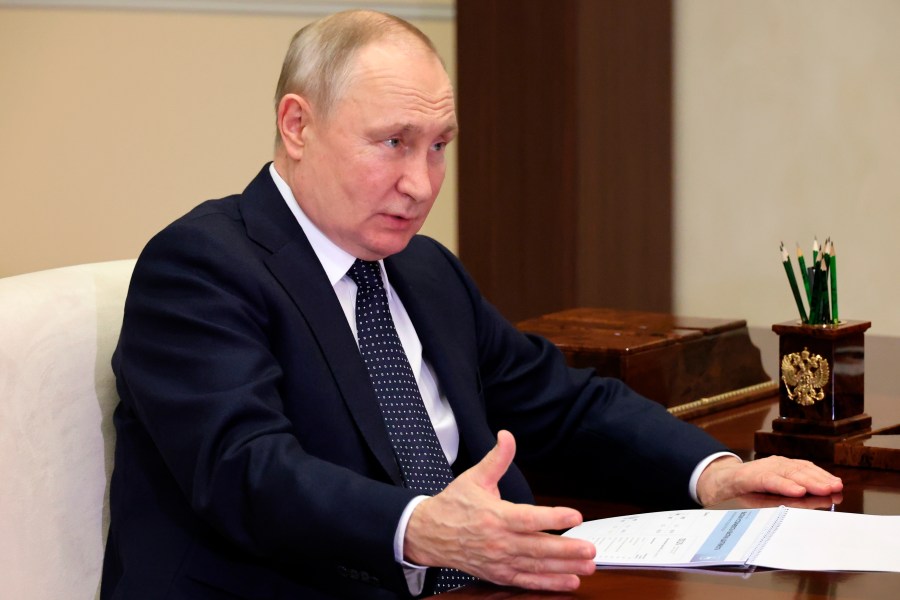 Russian President Vladimir Putin gestures while speaking to the Governor of the Nizhny Novgorod Region, Gleb Nikitin, during their meeting at the Novo-Ogaryovo residence outside Moscow, Russia, Wednesday, May 3, 2023. (Mikhail Klimentyev, Sputnik, Kremlin Pool Photo via AP)