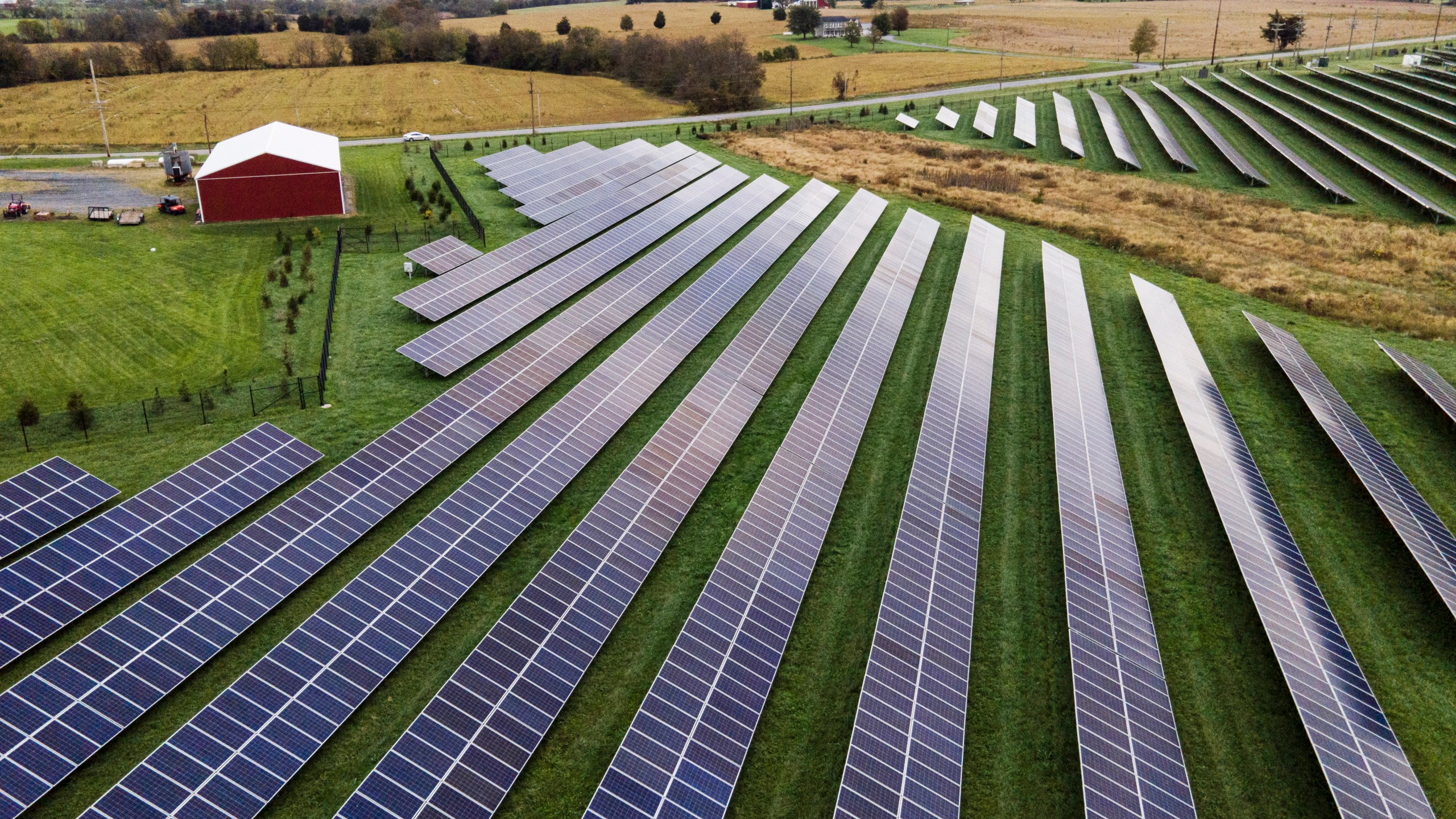 FILE - Farmland is seen with solar panels from Cypress Creek Renewables, Oct. 28, 2021, in Thurmont, Md. The Senate has approved a measure that would reinstate tariffs on solar panel imports from several Southeast Asian countries after President Joe Biden paused them in a bid to boost solar installations in the U.S. (AP Photo/Julio Cortez, File)