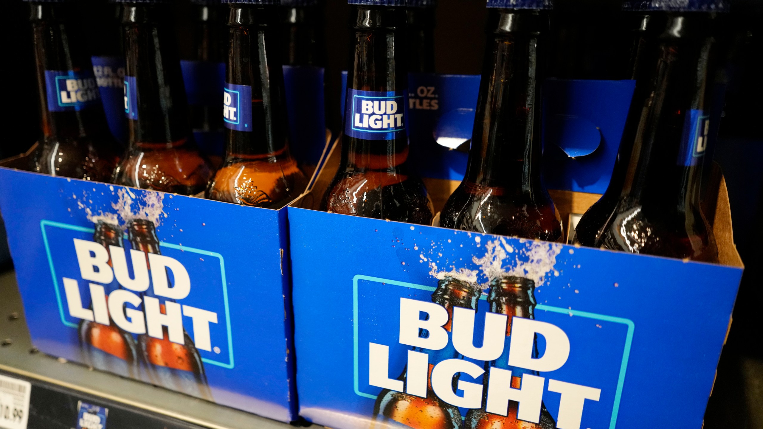 FILE - Bottles of Bud Light beer sit on a shelf at a grocery store on April 25, 2023, in Glenview, Ill. Bud Light's parent company said Thursday, May 4, that it will triple its marketing spending in the U.S. this summer as it tries to boost sales that plummeted after the brand partnered with a transgender influencer. (AP Photo/Nam Y. Huh, File)