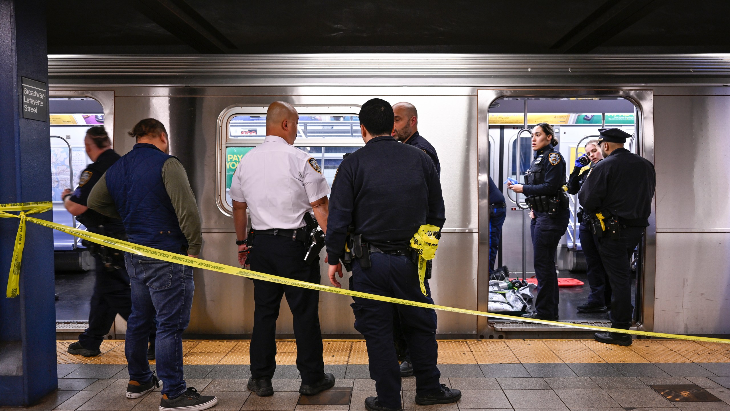 New York police officers respond to the scene where a fight was reported on a subway train, Monday, May 1, 2023, in New York. A man suffering an apparent mental health episode aboard a New York City subway died on Monday after being placed in a headlock by a fellow rider, according to police officials and video of the encounter. Jordan Neely, 30, was shouting and pacing aboard an F train in Manhattan witnesses and police said, when he was taken to the floor by another passenger. (Paul Martinka via AP)