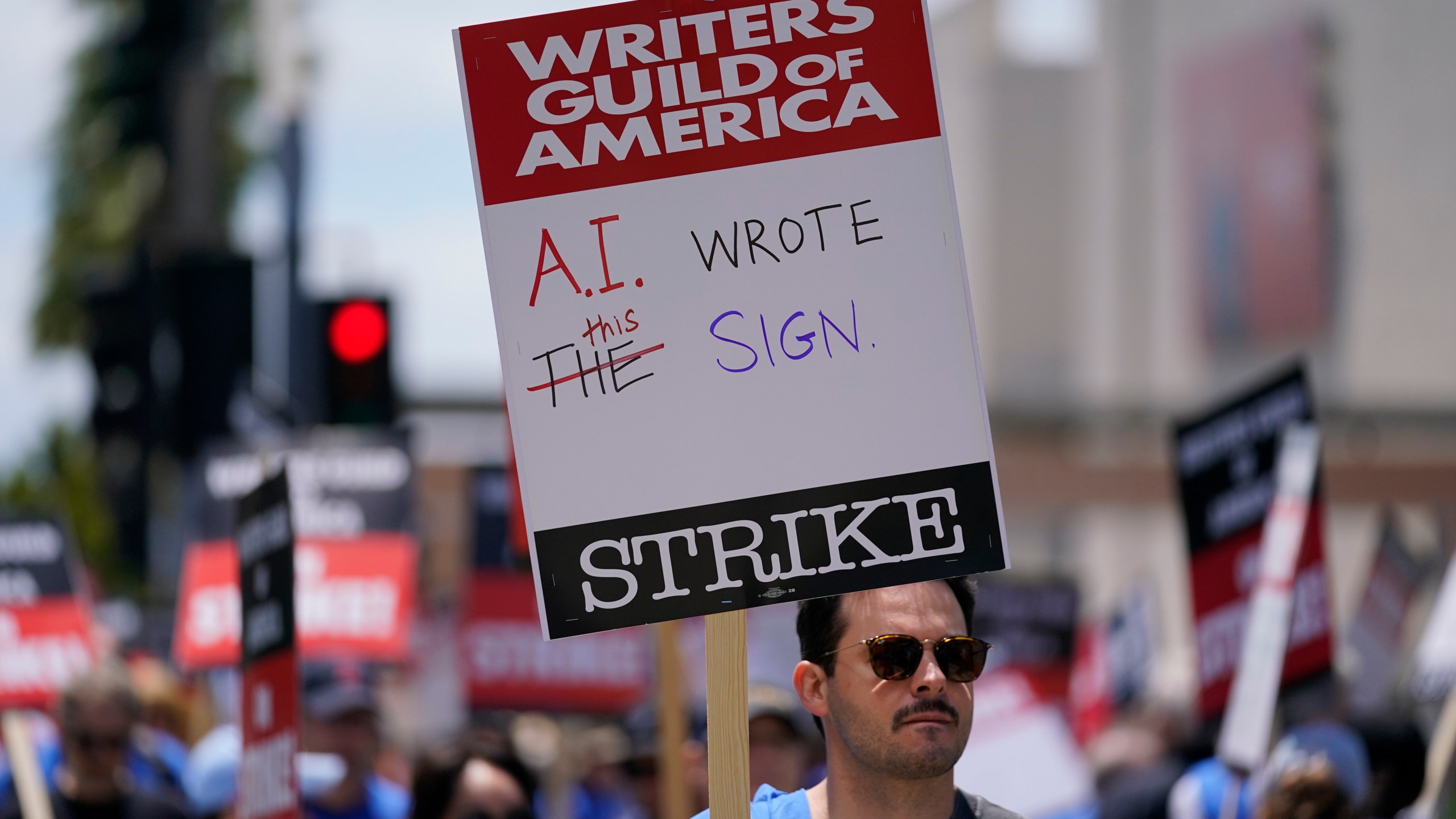 Members of the The Writers Guild of America picket outside Fox Studios on Tuesday, May 2, 2023, in Los Angeles. Hollywood writers picketing to preserve pay and job security outside major studios and streamers braced for a long fight at the outset of a strike that immediately forced late-night shows into hiatus and numerous other productions on hold. (AP Photo/Ashley Landis)