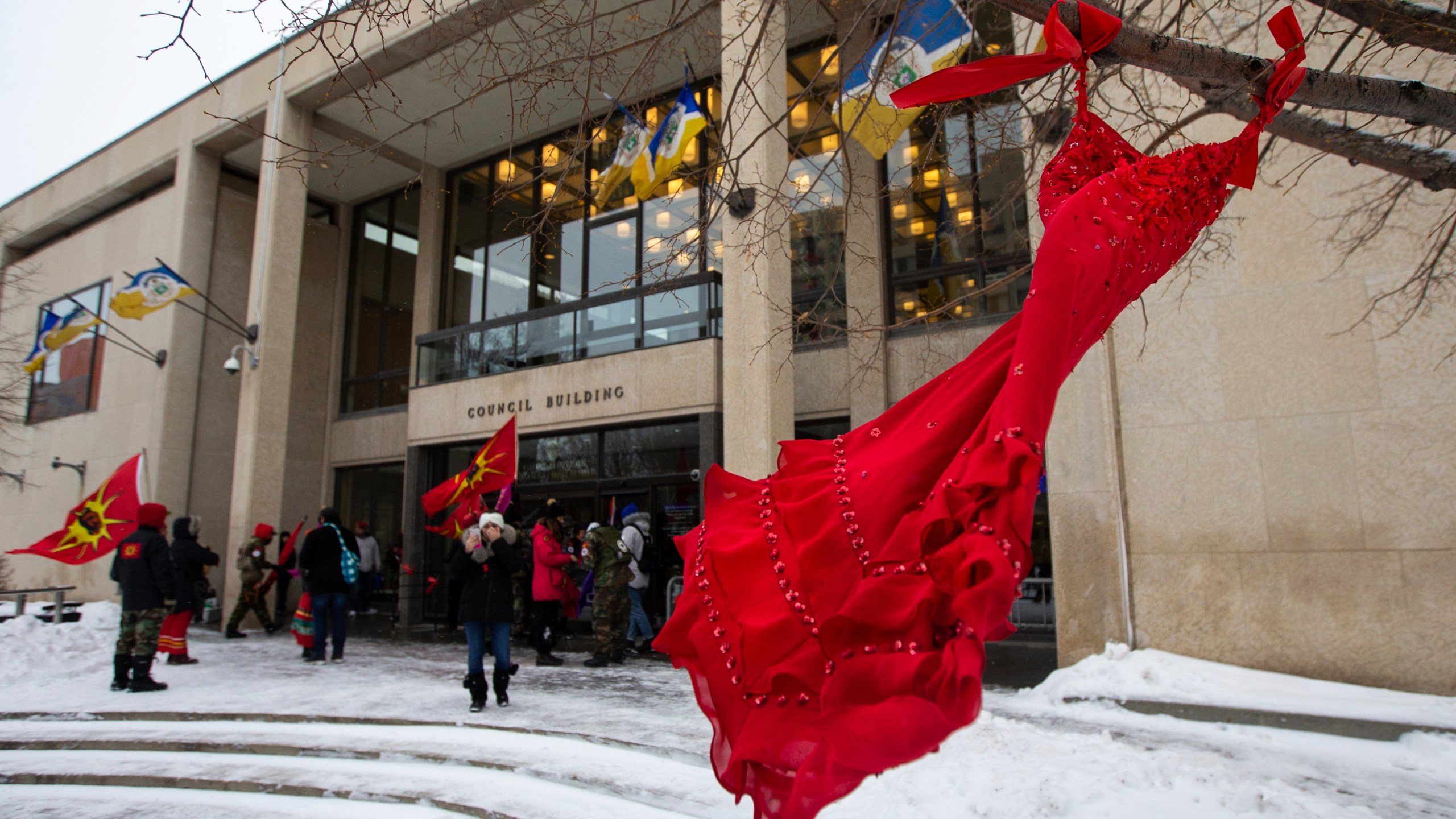 FILE - A red dress hangs on a tree in the courtyard at Winnipeg City Hall during a rally, Thursday, Dec. 15, 2022, in Winnipeg, Manitoba, to call on the city to cease dumping operations at Brady landfill and conduct a search for the remains of missing and murdered indigenous women believed to be buried there. Friday, May 5, 2023, marks Missing and Murdered Indigenous Peoples Awareness Day, a solemn day meant to draw more attention to the disproportionate number of Indigenous people who have vanished or have faced violence. (Daniel Crump/The Canadian Press via AP, File)