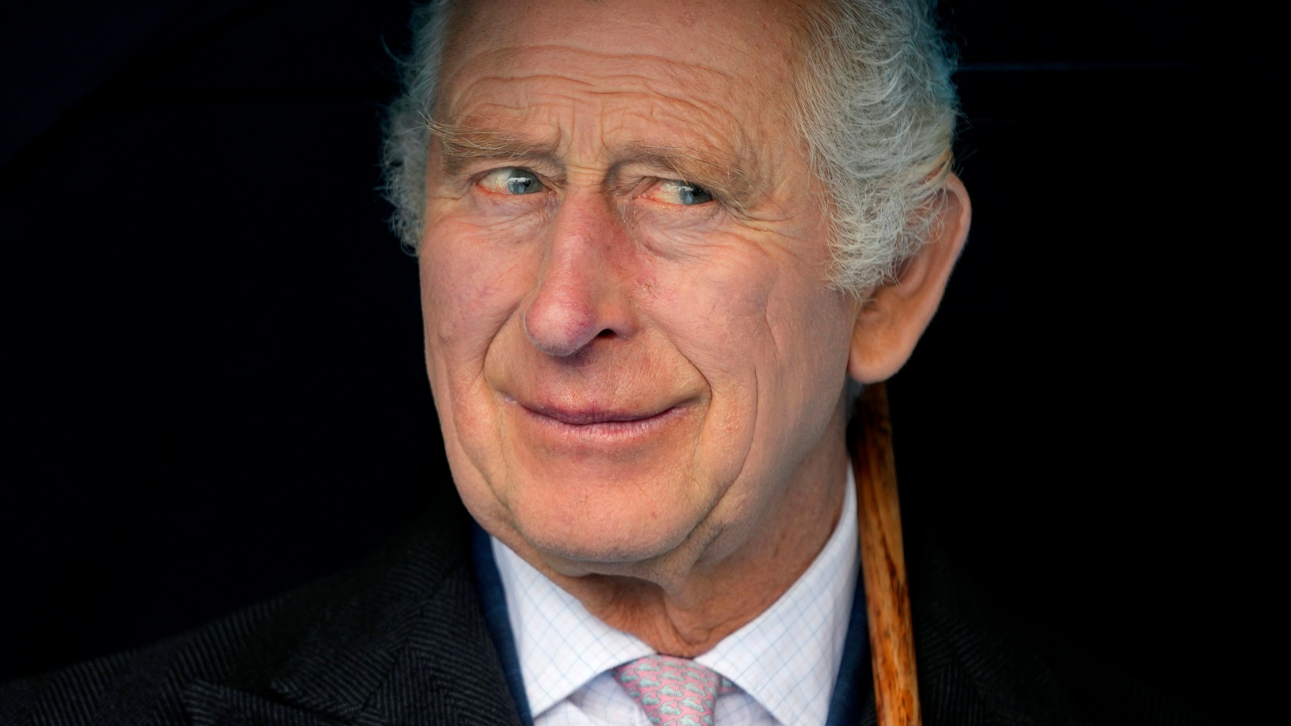 FILE - Britain's King Charles III smiles during a boat trip, in Hamburg, Germany, Friday, March 31, 2023. King Charles III arrived Wednesday for a three-day official visit to Germany. Britain’s royal family turns the page on a new chapter with the coronation of King Charles III. Charles ascended the throne when his mother, Queen Elizabeth II, died last year. But the coronation Saturday is a religious ceremony that provides a more formal confirmation of his role as head of state and titular head of the Church of England. (AP Photo/Matthias Schrader, Pool, File)