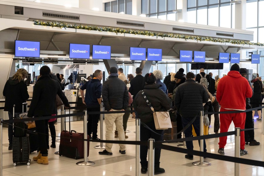 FILE - Passengers wait in line to check in for their flights at Southwest Airlines service desk at LaGuardia Airport, on Dec. 27, 2022, in New York. The Biden administration is working on new regulations that would require airlines to compensate passengers and cover their meals and hotel rooms if they are stranded for reasons within the airline's control. The White House said President Joe Biden and Transportation Secretary Pete Buttigieg would announce the start of the rulemaking process Monday May 8, 2023. (AP Photo/Yuki Iwamura, File)