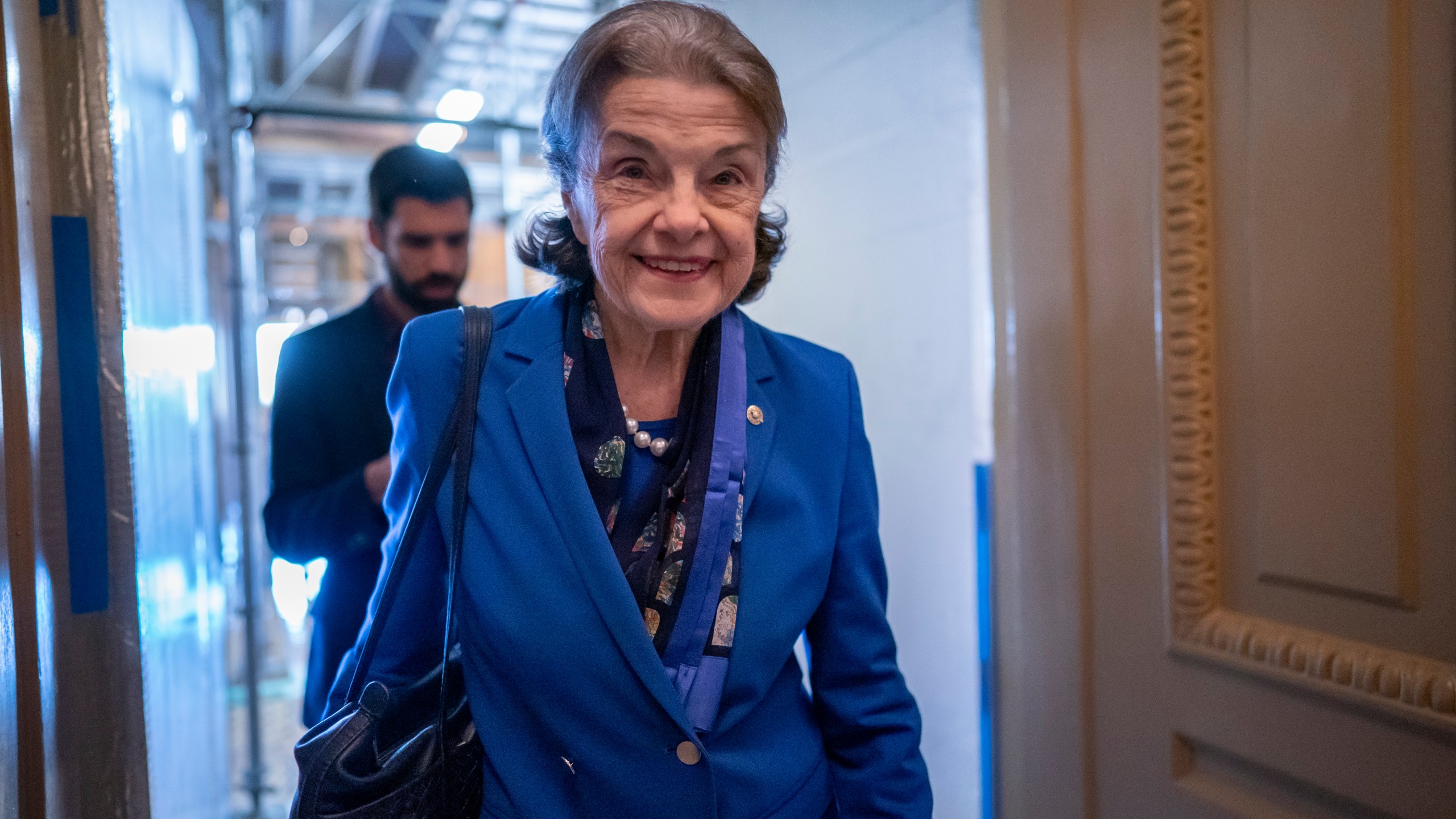 FILE - Sen. Dianne Feinstein, D-Calif., walks through a Senate corridor at the Capitol in Washington, Feb. 14, 2023. Feinstein is returning to Washington after a more than two month absence led to calls from within her own party for the oldest member of Congress to resign. The California Democrat announced in early March that she had been hospitalized in San Francisco and was being treated for a case of shingles. The 89-year-old senator planned to be back in Washington in March but never appeared as her recovery took longer than expected. (AP Photo/J. Scott Applewhite, File)