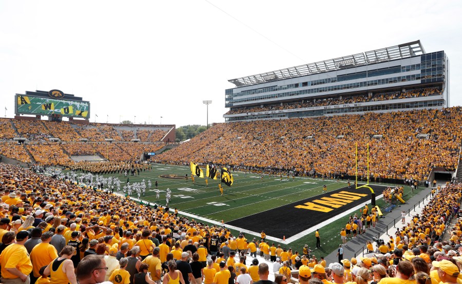 FILE - Fans cheer before an NCAA college football game between Iowa and North Texas at Kinnick Stadium in Iowa City, Iowa, Sept. 16, 2017. The University of Iowa announced 26 of its athletes across five sports are alleged to have participated in sports wagering in violation of NCAA rules. (AP Photo/Charlie Neibergall, File)