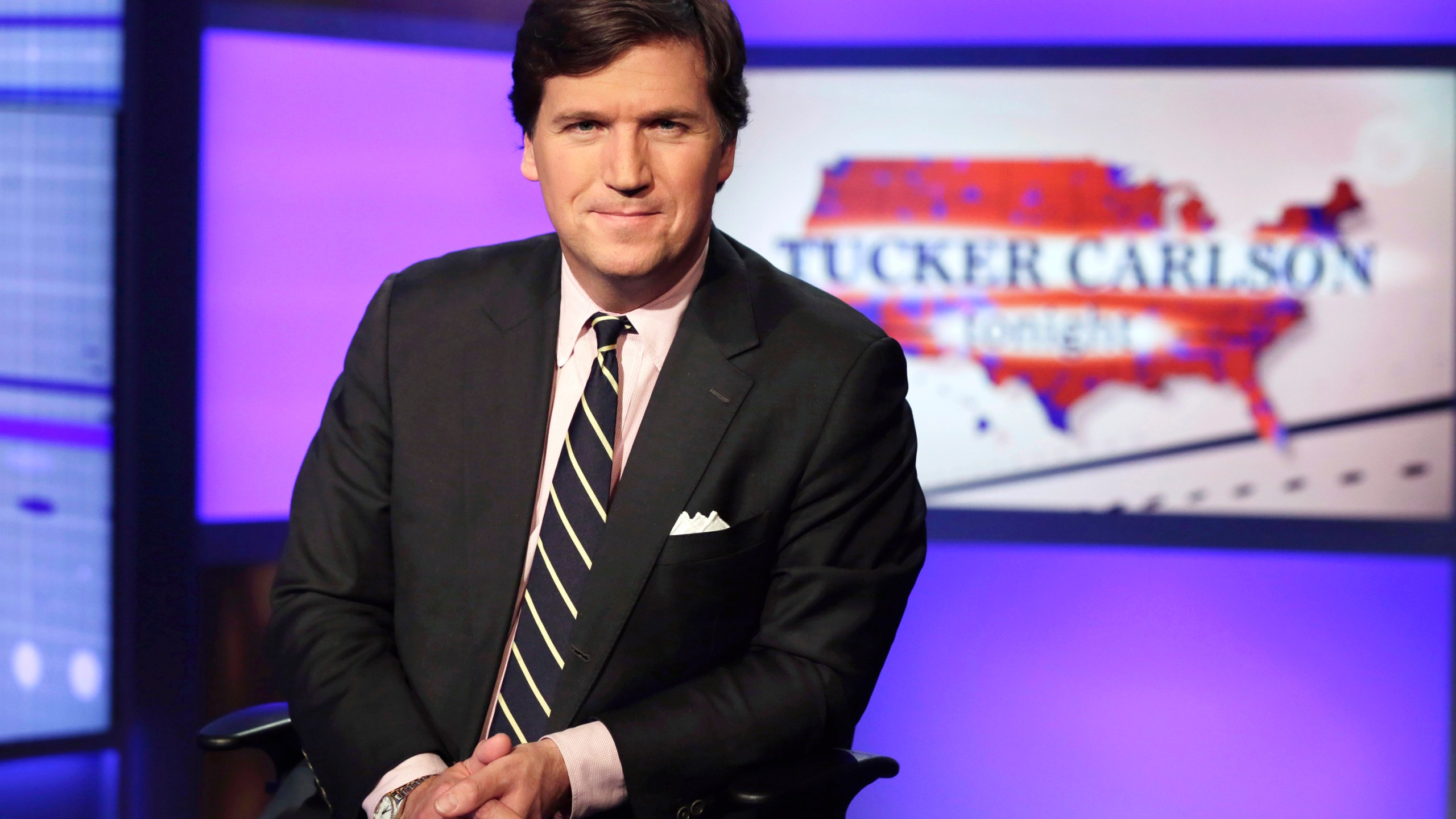 FILE - Tucker Carlson, host of "Tucker Carlson Tonight," poses for photos in a Fox News Channel studio on March 2, 2017, in New York. Fired Fox news host Carlson said Tuesday, May 9, 2023, that he will be putting out a “new version” of his program on Twitter. (AP Photo/Richard Drew, File)