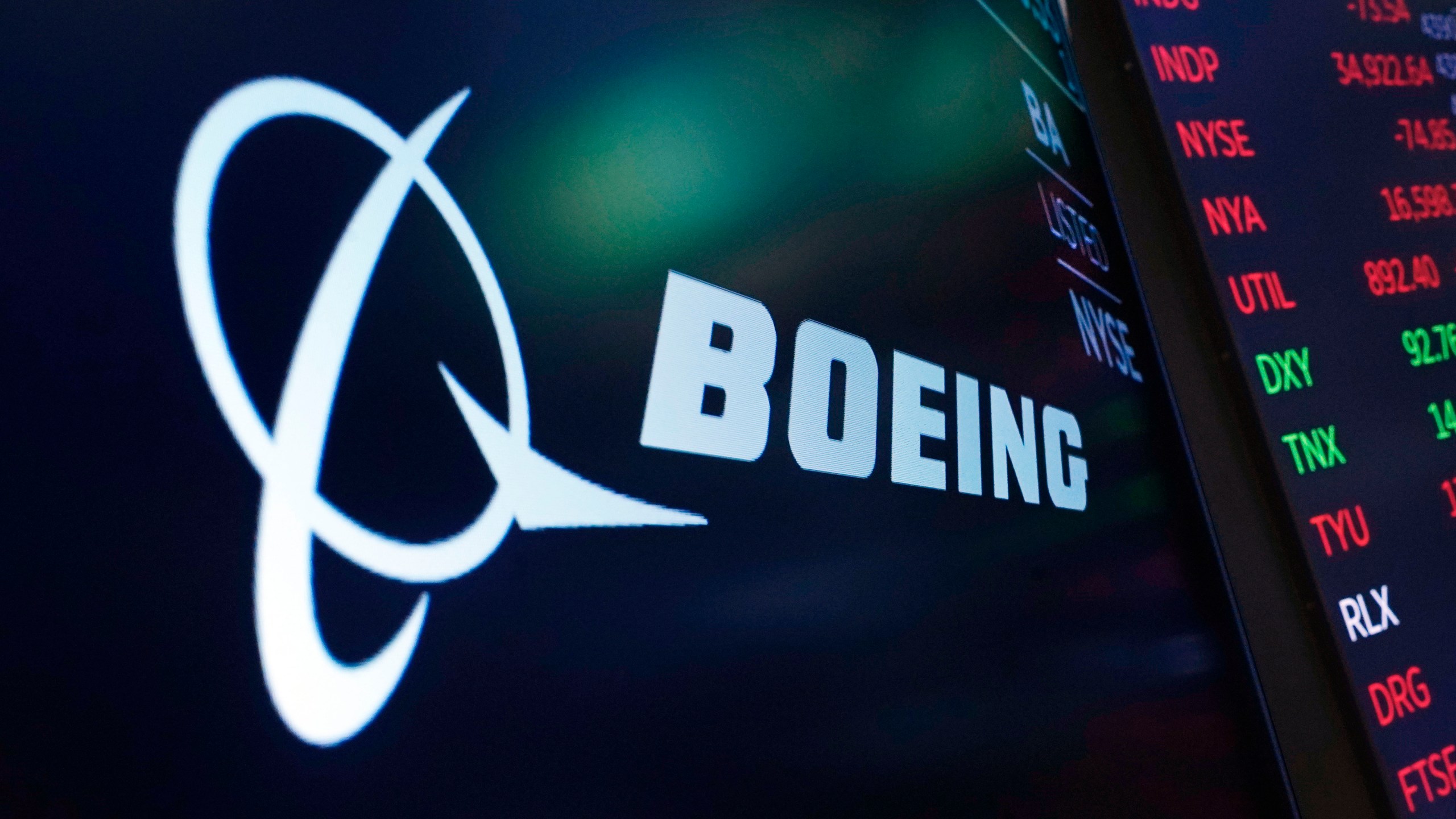 FILE - The logo for Boeing appears on a screen above a trading post on the floor of the New York Stock Exchange, July 13, 2021. Boeing reports earnings on Wednesday, April 26, 2023. (AP Photo/Richard Drew, file)