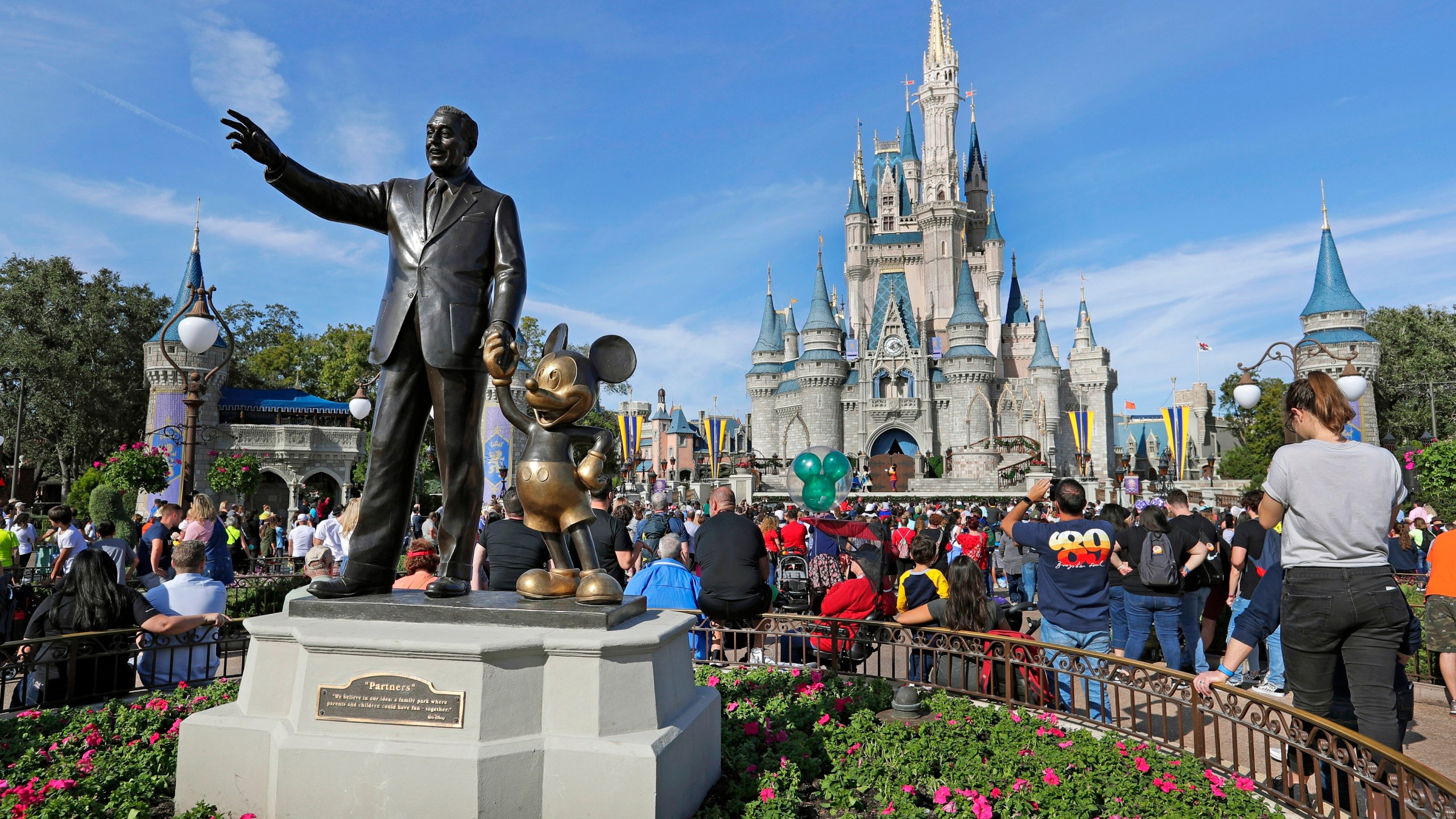 FILE - In this Jan. 9, 2019 photo, a statue of Walt Disney and Micky Mouse stands in front of the Cinderella Castle at the Magic Kingdom at Walt Disney World in Lake Buena Vista, Fla. The Walt Disney Co. will be laying off several thousand employees in the week starting Monday, April 24, 2023, a second round of cuts that's part of a previously announced plan to eliminate 7,000 jobs this year. (AP Photo/John Raoux)