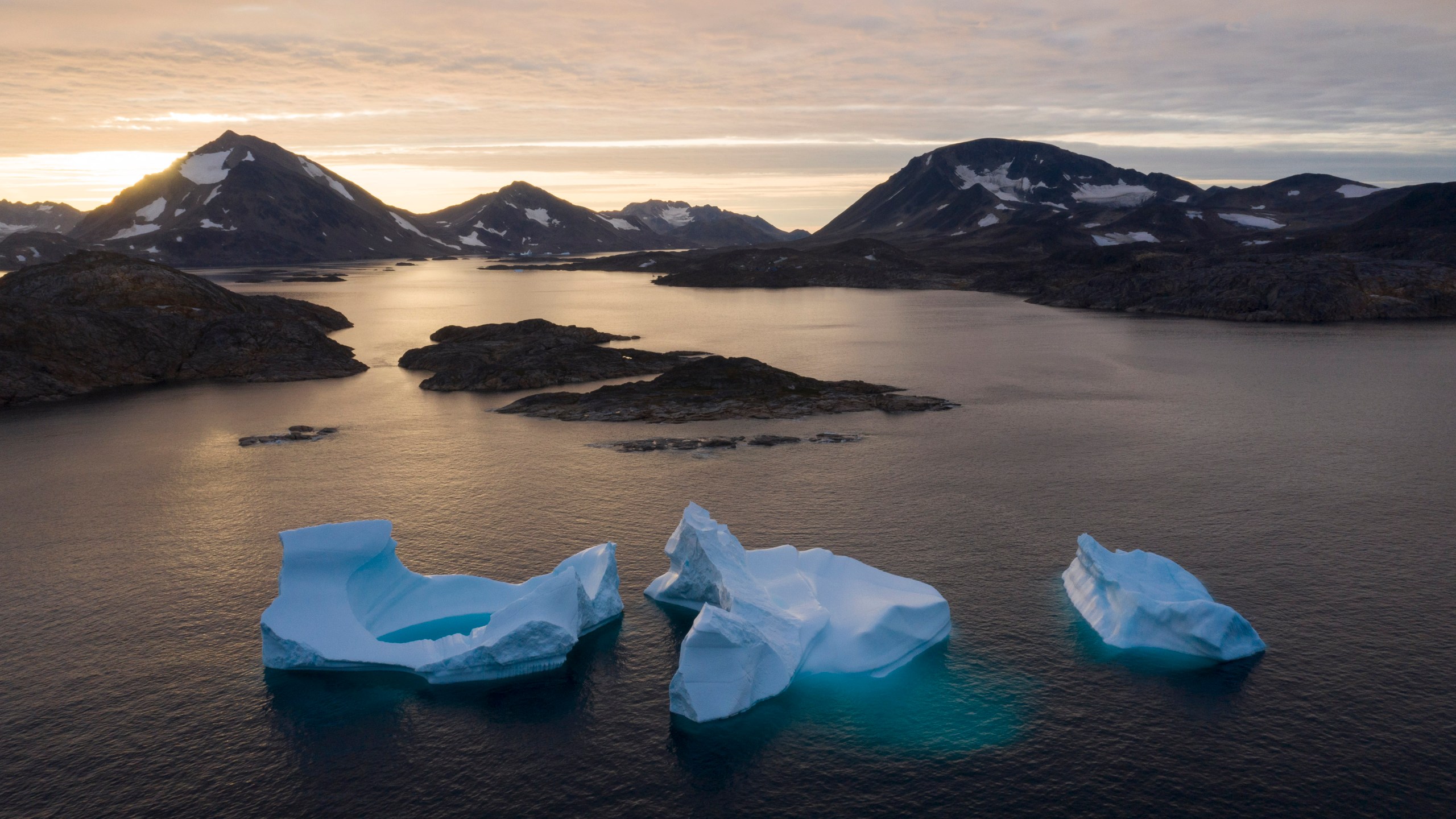 FILE - Large Icebergs float away as the sun rises near Kulusuk, Greenland, Aug. 16, 2019. Norway has taken over the Arctic Council’s rotating presidency from Russia on Thursday, May 11, 2023 amid concerns that the work of the eight-country intergovernmental body on protecting the sensitive environment is at risk due to suspension of cooperation with Moscow over the Ukraine war. Research involving Russia ranging from climate work to mapping polar bears have been put on hold and scientists have lost access to important facilities in the Russian Arctic. (AP Photo/Felipe Dana, File)