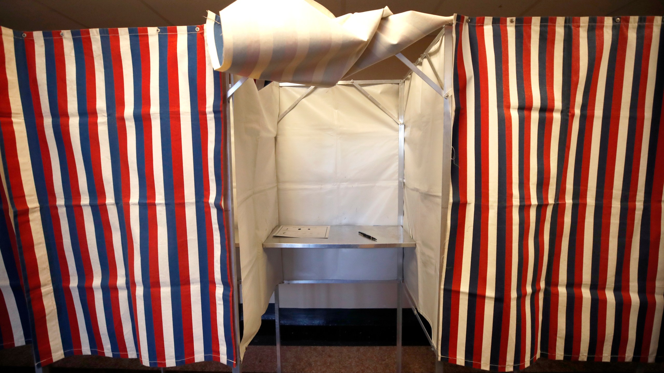 FILE - A booth is ready for a voter, Feb. 24, 2020, at City Hall in Cambridge, Mass., on the first morning of early voting in the state. (AP Photo/Elise Amendola, File)
