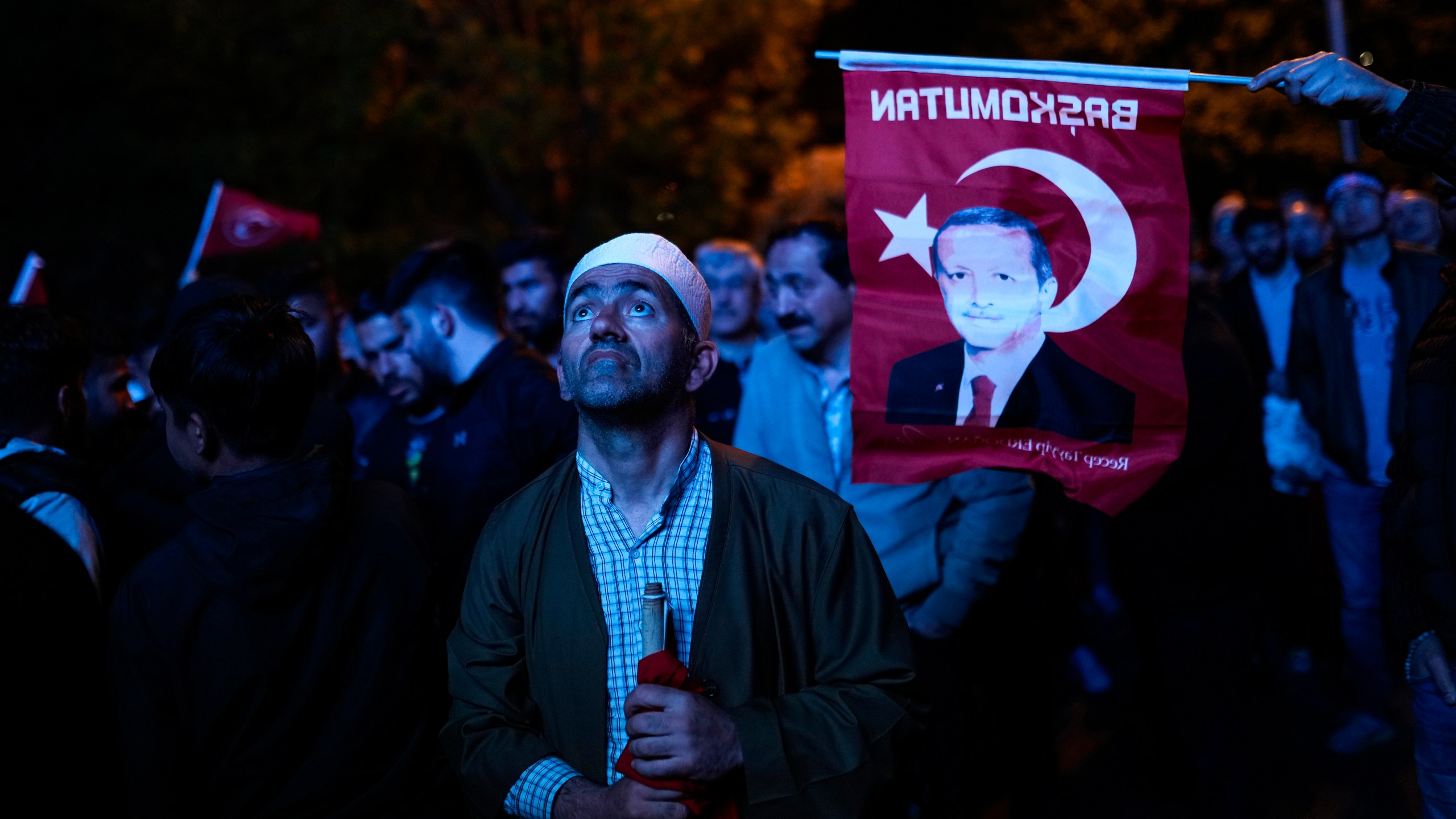 Supporters of Turkish President Recep Tayyip Erdogan watch news on a giant screen outside AKP (Justice and Development Party) headquarters in Istanbul, Turkey, Sunday, May 14, 2023. More than 64 million people, including 3.4 million overseas voters, were eligible to vote. (AP Photo/Francisco Seco)