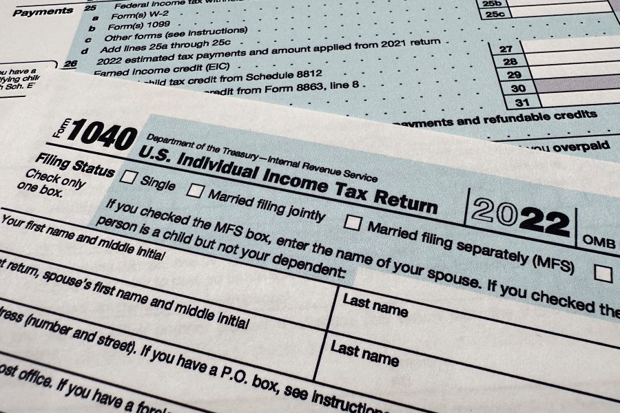 FILE - The Internal Revenue Service 1040 tax form for 2022 is seen on April 17, 2023. The IRS is planning to launch a pilot program for a government-run, online tax filing system that’s free for all. After months of research, the IRS published a feasibility report on Tuesday, May 16, 2023, laying out taxpayer interest in direct file, how the system could work, its potential cost, operational challenges and more. (AP Photo/Jon Elswick, File)