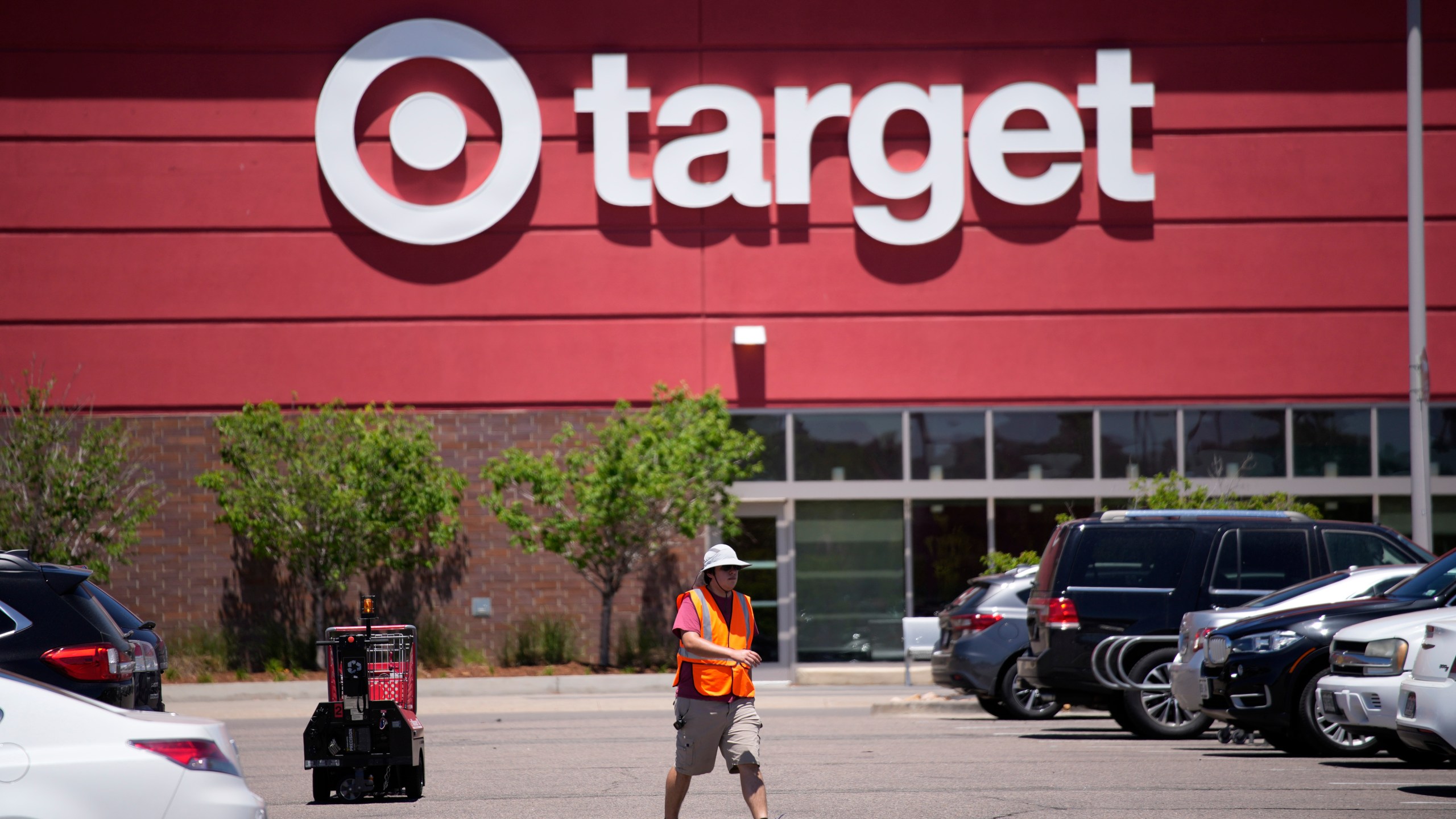 FILE - A worker collects shopping carts in the parking lot of a Target store on June 9, 2021, in Highlands Ranch, Colo. Target on Wednesday May 17, 2023 reported another quarterly profit decline and issued a cautious sales and profit outlook for the current period. (AP Photo/David Zalubowski, File)