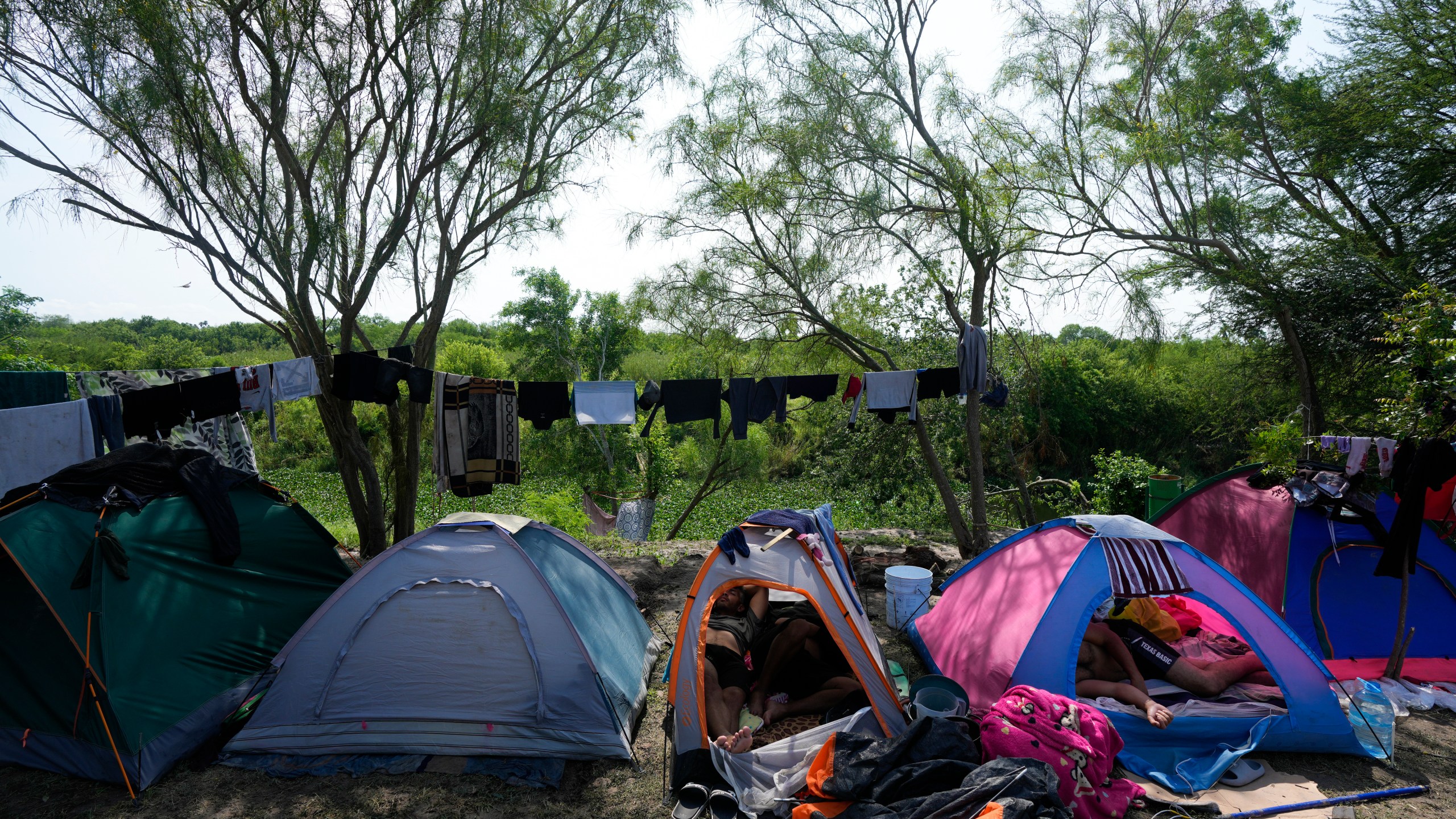 Venezuelan migrants rest inside their tents on the bank of the Rio Grande in Matamoros, Mexico, Sunday, May 14, 2023. As the U.S. ended its pandemic-era immigration restrictions, migrants are adapting to new asylum rules and legal pathways meant to discourage illegal crossings. (AP Photo/Fernando Llano)