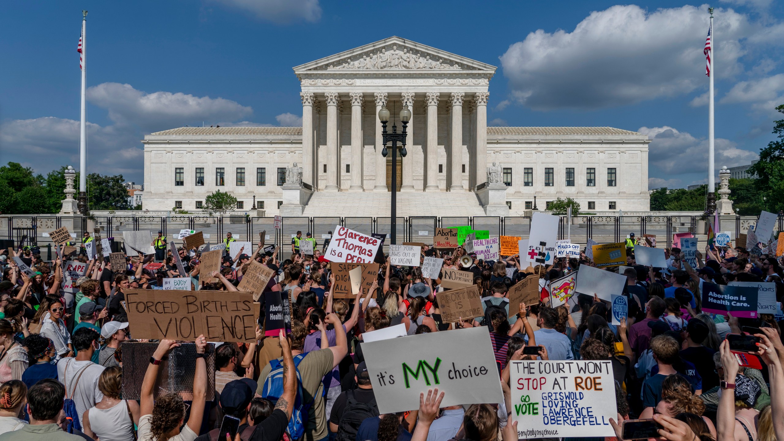 FILE - Abortion-rights and anti-abortion demonstrators gather outside of the Supreme Court in Washington, Friday, June 24, 2022. Confidence in the Supreme Court sank to its lowest point in at least 50 years in 2022, in the wake of the Dobbs decision that led to state bans and other restrictions on abortion. That's according to the General Social Survey, a long-running and widely respected survey conducted by NORC at the University of Chicago that has been measuring confidence in the court since 1973, the same year that Roe v. Wade legalized abortion nationwide.(AP Photo/Gemunu Amarasinghe, File)