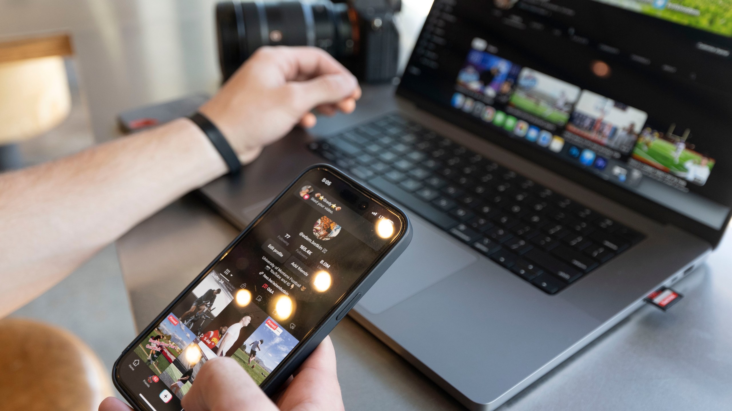 Adam Botkin, a football TikTok influencer, edits a video for a post at a Chipotle Mexican Grill while eating dinner in Missoula, Mont., on Wednesday, May 3, 2023. Botkin, a former walk-on place kicker and punter for the Montana Grizzlies, gained notoriety on the social media platform after videos of him performing kicking tricks went viral. (AP Photo/Tommy Martino)