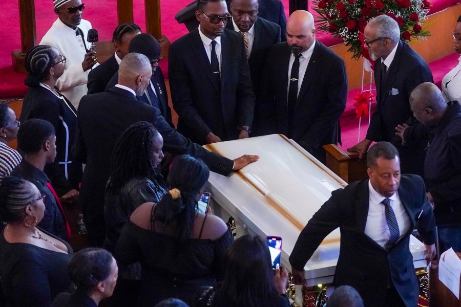 Andre Zachery, father of Jordan Neely places his hand on Neely's casket, after a funeral service at Harlem's Mount Neboh Baptist Church, Friday May 19, 2023, in New York. Neely, a former Michael Jackson impersonator who had been struggling with mental illness and homelessness in recent years, died May 1 when a fellow subway rider pinned him to the floor of a subway car in a chokehold that lasted several minutes. (AP Photo/Bebeto Matthews)