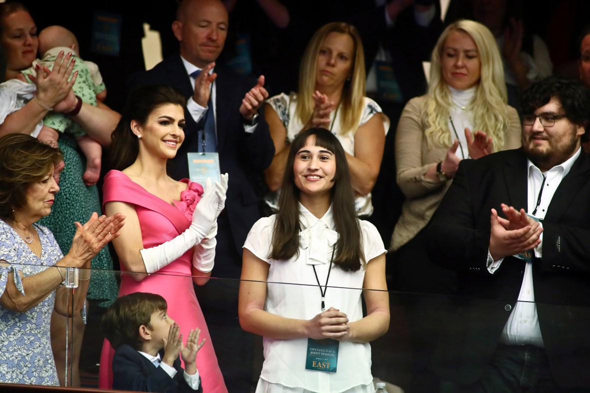 FILE - Chloe Cole, center, is recognized by Florida Gov. Ron DeSantis during a joint session for his State of the State speech Tuesday, Mar. 7, 2023 at the Capitol in Tallahassee, Fla. At left, is Florida first lady Casey DeSantis. Cole received puberty blockers when she was 13, and underwent a double mastectomy at 16. Now she is an advocate against allowing those procedures on children. (AP Photo/Phil Sears, File)