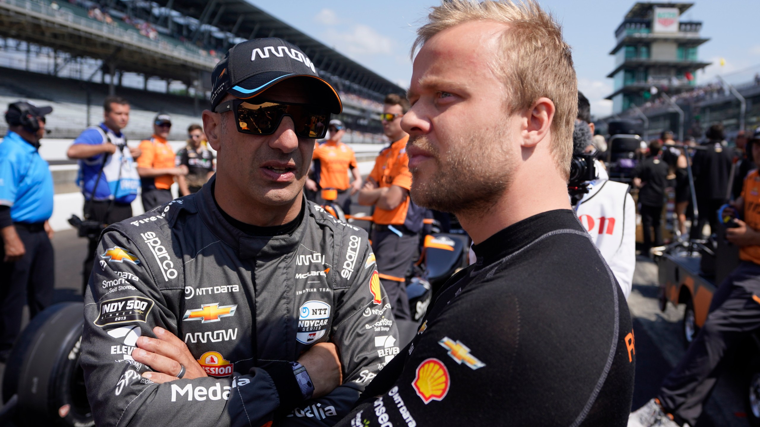 Tony Kanaan, left, of Brazil, talks with Felix Rosenqvist, of Sweden, during qualifications for the Indianapolis 500 auto race at Indianapolis Motor Speedway, Saturday, May 20, 2023, in Indianapolis. (AP Photo/Darron Cummings)