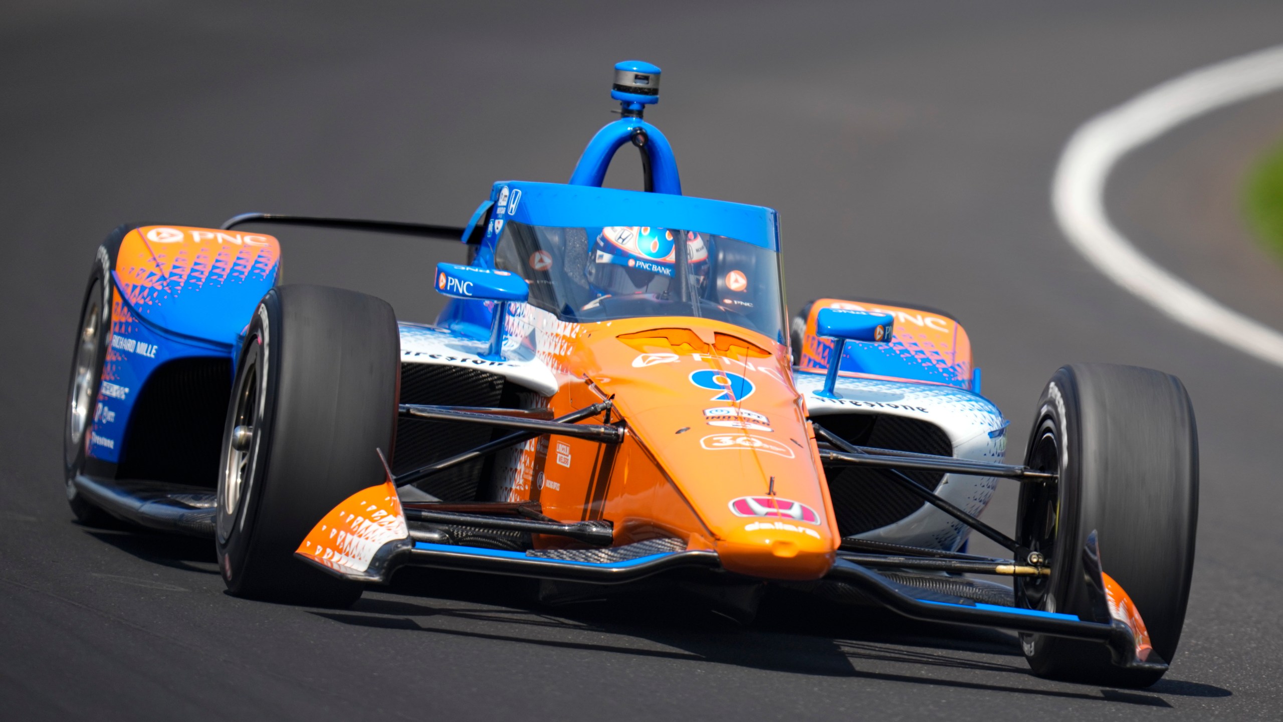 Scott Dixon, of New Zealand, drives through the first turn during qualifications for the Indianapolis 500 auto race at Indianapolis Motor Speedway in Indianapolis, Saturday, May 20, 2023. (AP Photo/Michael Conroy)