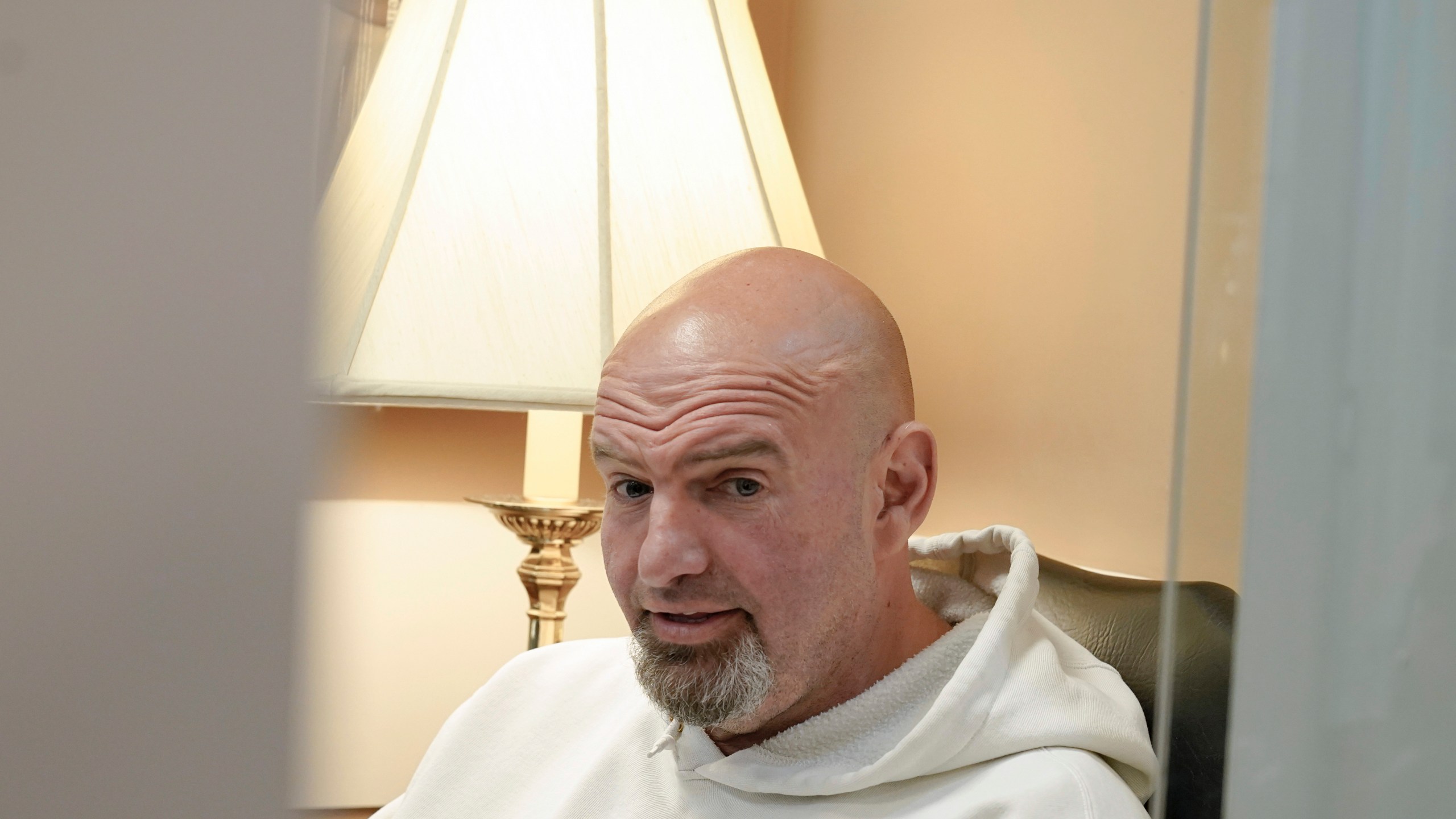 FILE - Sen. John Fetterman, D-Pa., sits before a news conference on the debt limit, Thursday, May 18, 2023, on Capitol Hill in Washington. Before Fetterman checked himself in to the hospital for clinical depression in February, he walked the halls of the Senate stony-faced and dressed in formal suits. These days, he’s back to wearing the hoodies and gym shorts he was known for before he became a senator. (AP Photo/Mariam Zuhaib, File)