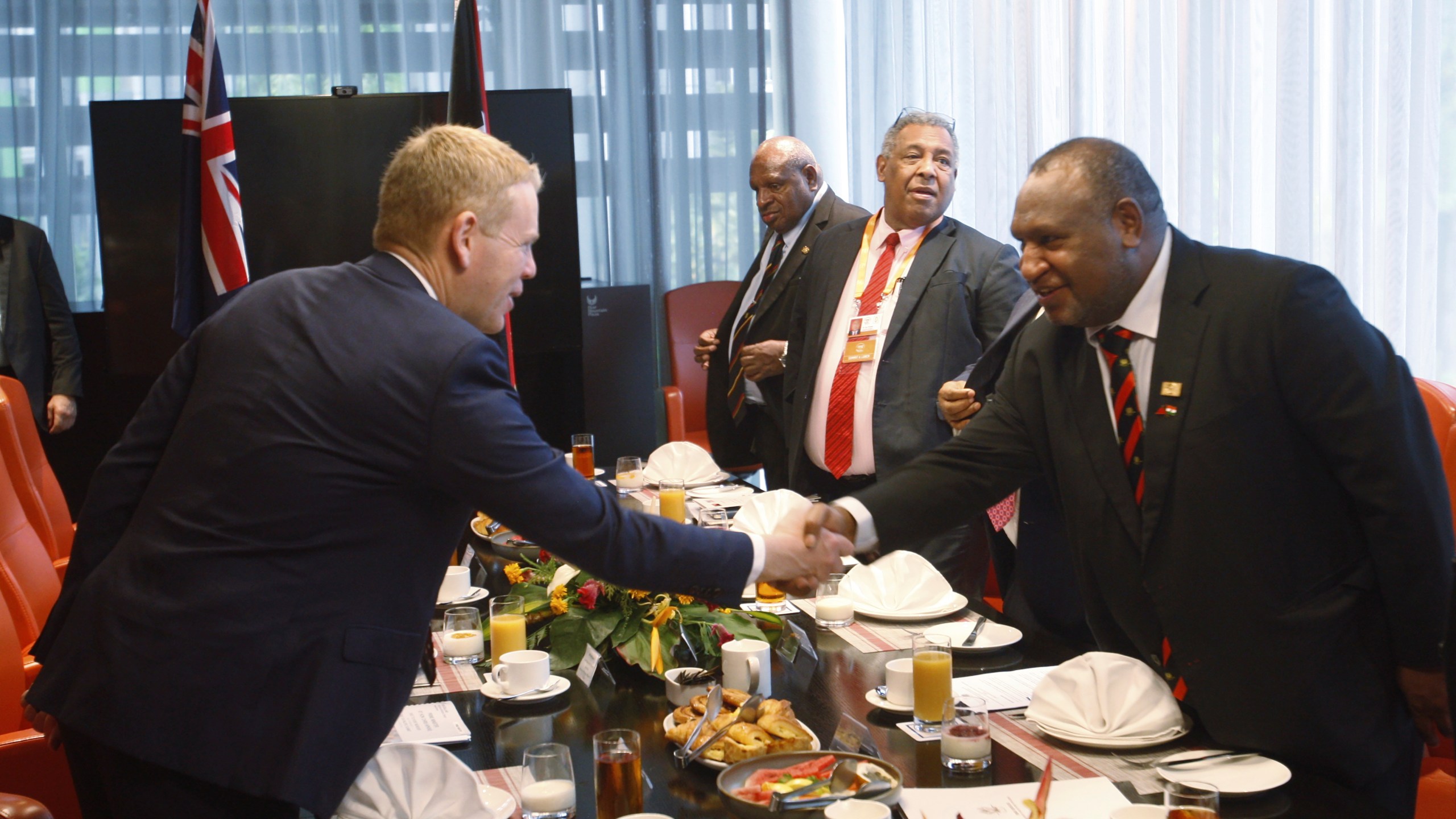 Papua New Guinea Prime Minister James Marape, right, shakes hands with New Zealand Prime Minister Chris Hipkins at a breakfast meeting in Port Moresby, Papua New Guinea, Monday, May 22, 2023. (AP Photo/Nick Perry)