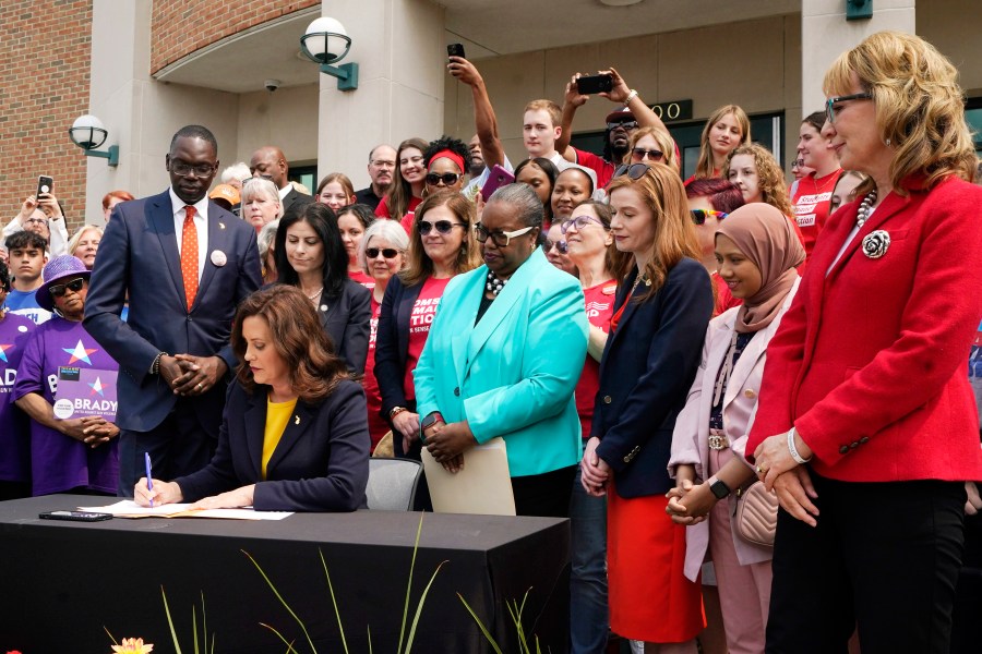 Michigan Gov. Gretchen Whitmer signs legislation, Monday, May 22, 2023, in Royal Oak, Mich. The package of legislation being signed will create extreme risk protection orders, which authorize family, police officers, or medical professionals to seek a court order to temporarily keep guns out of the hands of someone who represents a danger to themselves or others. (AP Photo/Carlos Osorio)