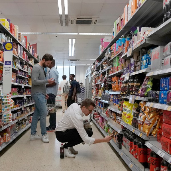 FILE - Shoppers buy food in a supermarket in London, Wednesday, Aug. 17, 2022. Official figures show that inflation in the U.K. has fallen to its lowest level since the immediate aftermath of Russia’s invasion of Ukraine which caused energy and food costs to surge. The Office for National Statistics said Wednesday that the consumer price index dropped to 8.7% in the year to April from 10.1% in March. (AP Photo/Frank Augstein, File)