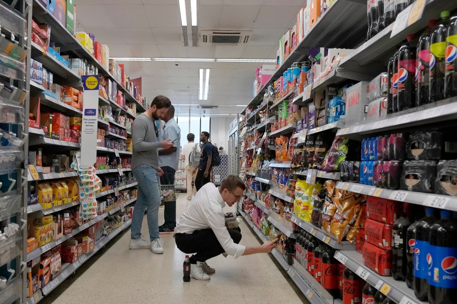 FILE - Shoppers buy food in a supermarket in London, Wednesday, Aug. 17, 2022. Official figures show that inflation in the U.K. has fallen to its lowest level since the immediate aftermath of Russia’s invasion of Ukraine which caused energy and food costs to surge. The Office for National Statistics said Wednesday that the consumer price index dropped to 8.7% in the year to April from 10.1% in March. (AP Photo/Frank Augstein, File)