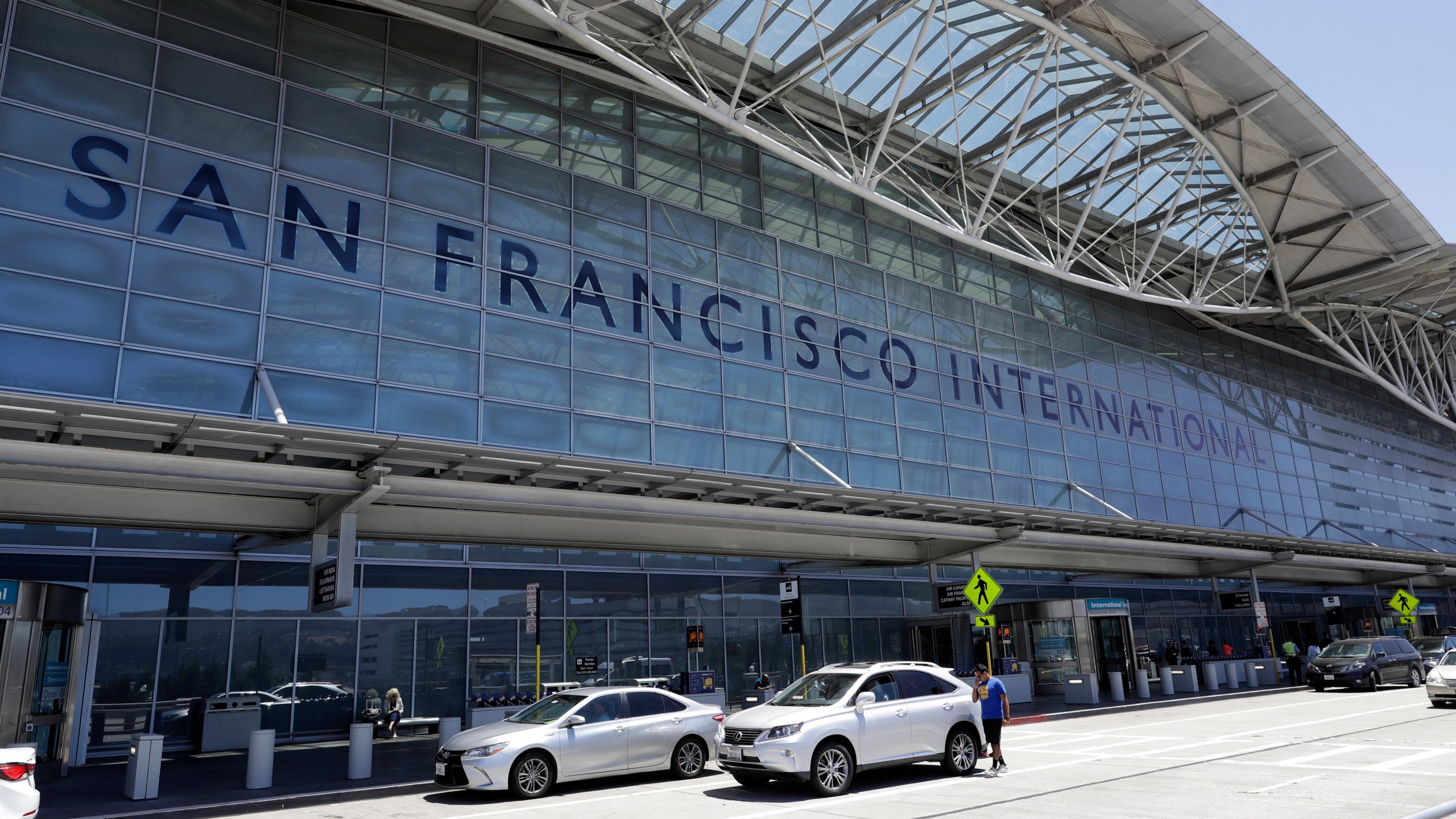 FILE - Vehicles wait outside the international terminal at San Francisco International Airport in San Francisco on July 11, 2017. Two airliners aborted landings at San Francisco International Airport on May 19, 2023, after pilots spotted a Southwest Airlines jet taxiing across runways on which the other planes had been cleared to land. The Federal Aviation Administration said Thursday, May 25, that it reviewed the matter and determined that appropriate steps were taken to ensure safety. (AP Photo/Marcio Jose Sanchez, File)