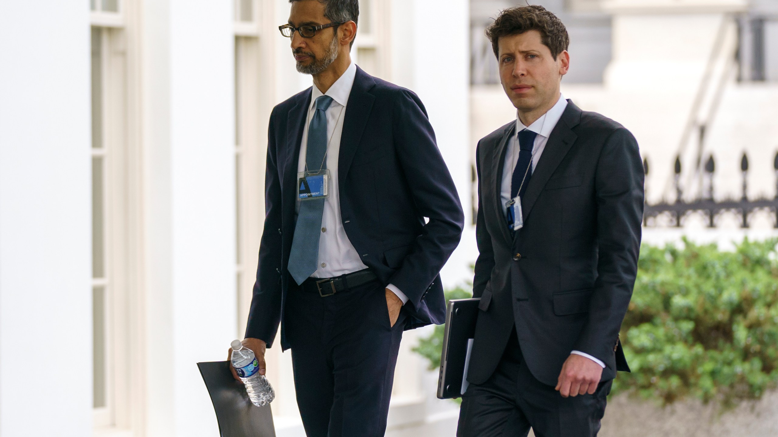 File - Alphabet CEO Sundar Pichai, left, and OpenAI CEO Sam Altman arrive to the White House for a meeting with Vice President Kamala Harris on artificial intelligence, Thursday, May 4, 2023, in Washington. As concerns grow over increasingly powerful artificial intelligence systems like ChatGPT, the nation's financial watchdog says it's working to ensure that companies follow the law when they're using AI. (AP Photo/Evan Vucci, File)