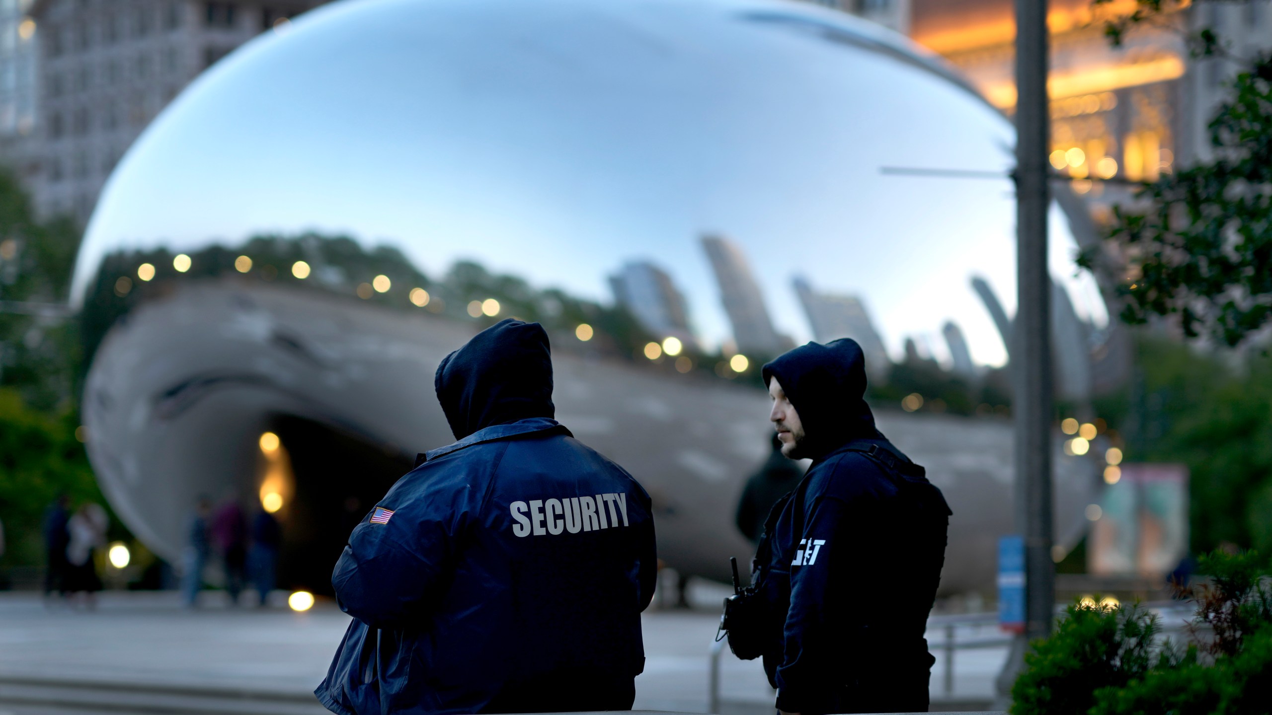 *Private security personnel patrol the area around Anish Kapoor's stainless steel sculpture Cloud Gate, also known as "The Bean," in Chicago's Millennium Park Thursday, May 25, 2023. Chicago is heading into the Memorial Day weekend hoping to head off violence that tends to surge with rising temperatures of summer. Even the state of Illinois is assisting by sending in what it's called "peacekeepers" in an attempt to deescalate violent situations. (AP Photo/Charles Rex Arbogast)