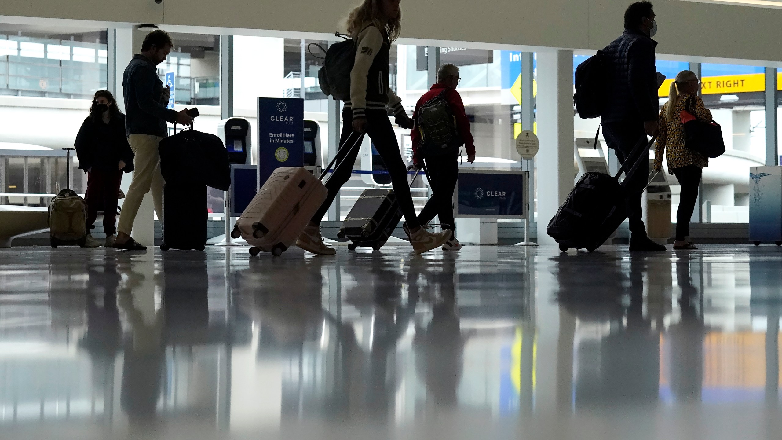 File - Travelers walk through a domestic terminal at San Francisco International Airport in San Francisco, Friday, May 26, 2023. On Wednesday, the Conference Board reports on U.S. consumer confidence for May. (AP Photo/Jeff Chiu, File)