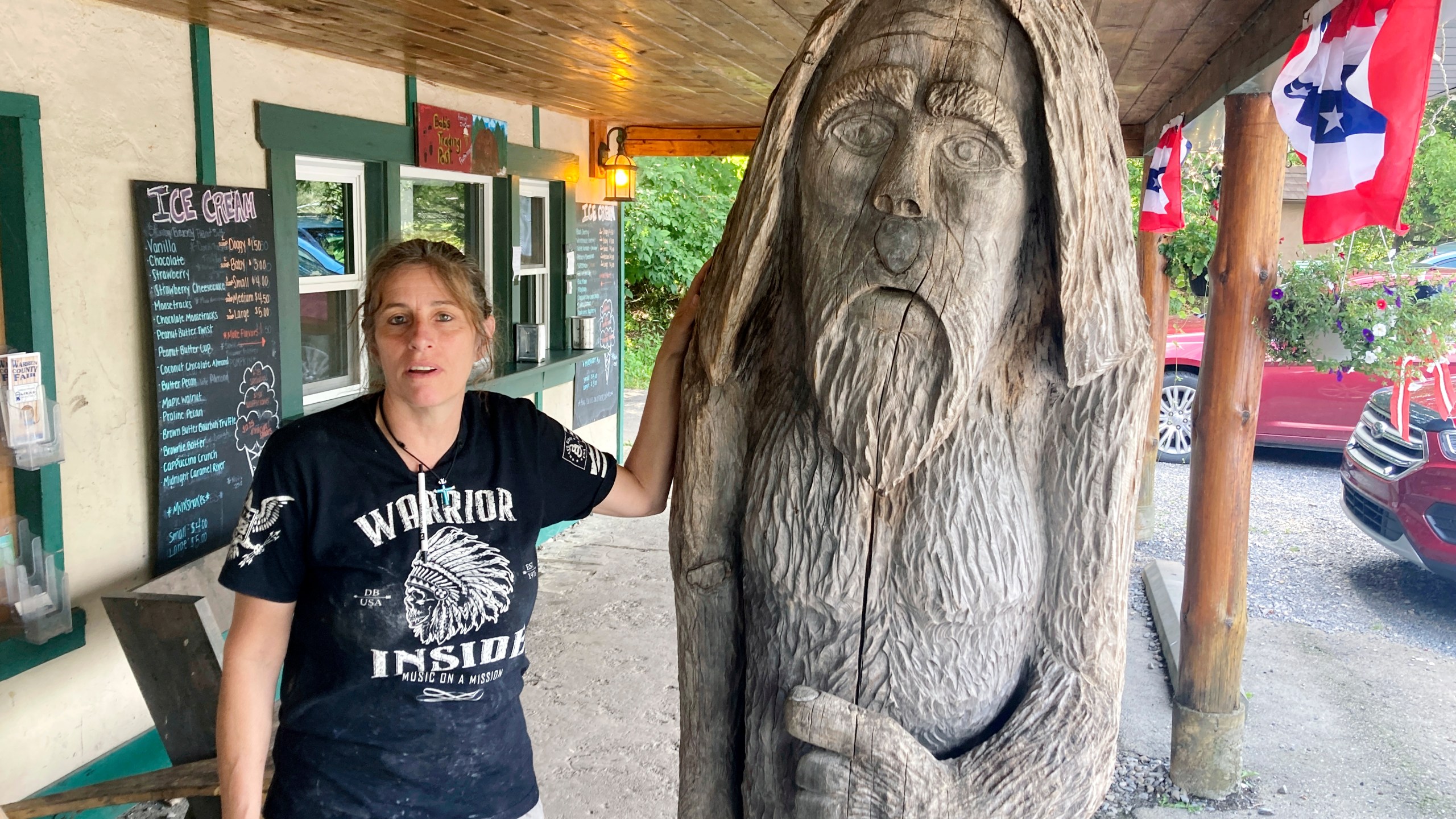 FILE - Pauline Bauer leans against a wooden statue outside Bob's Trading Post, her restaurant in Hamilton, Pa., July 21, 2021. Bauer, who screamed death threats directed at then-House Speaker Nancy Pelosi while storming the U.S. Capitol on Jan. 6, 2021, was sentenced on Tuesday to two years and three months in prison. (AP Photo/Michael Kunzelman)