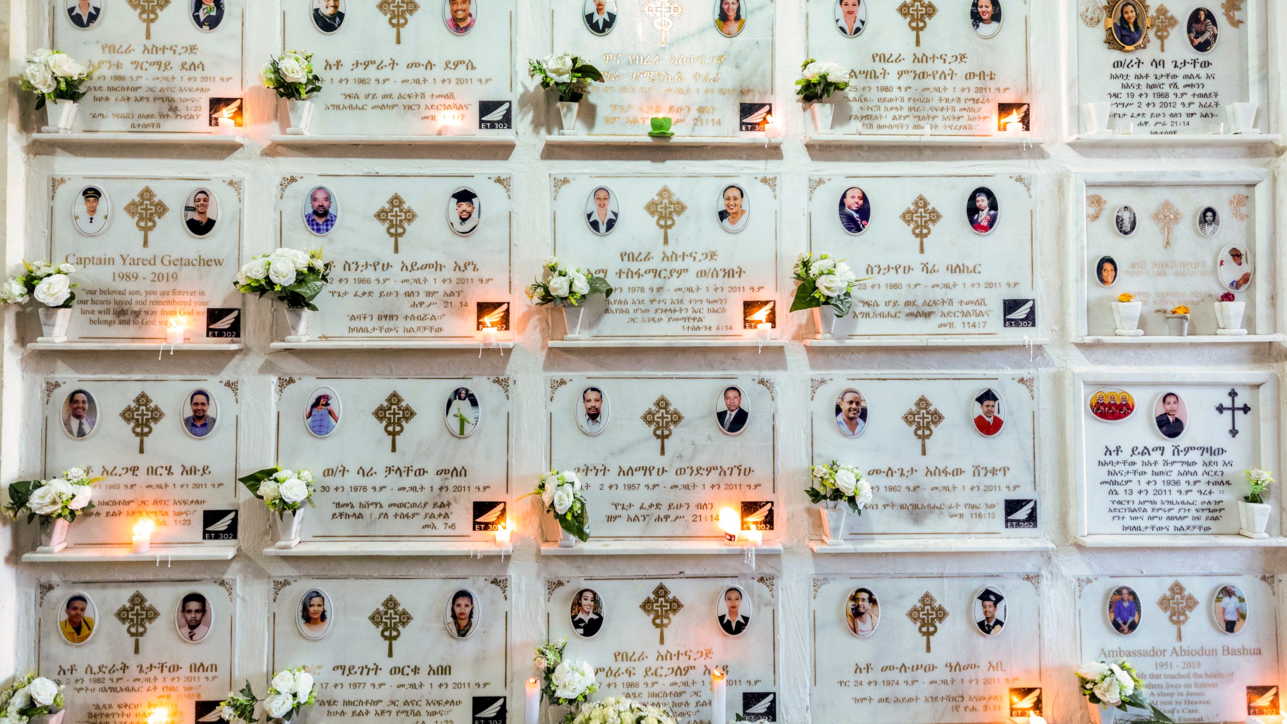 FILE - Candles are lit on a memorial wall during an anniversary memorial service at the Holy Trinity Cathedral in Addis Ababa, Ethiopia, March 8, 2020, to remember those who died when Ethiopian Airlines flight ET302, a Boeing 737 Max, crashed shortly after takeoff on March 10, 2019, killing all 157 on board. A federal judge is ruling that families of passengers who died in the crash can seek damages for the pain and terror suffered by their relatives before the plane crashed. The ruling posted Tuesday, May 30, 2023 is a setback for Boeing, which had argued that evidence about the victims’ suffering is speculative and would have an unfair impact on jurors. (AP Photo/Mulugeta Ayene, File)