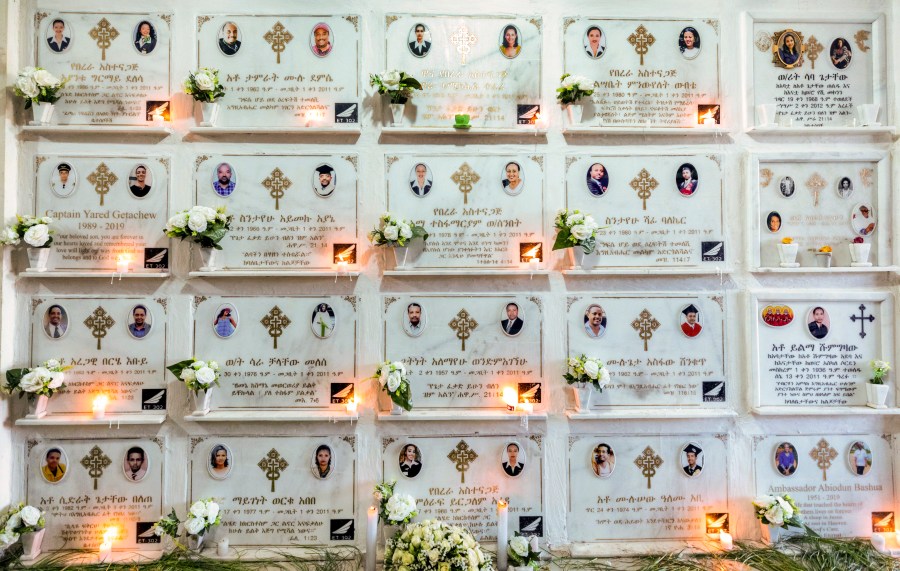 FILE - Candles are lit on a memorial wall during an anniversary memorial service at the Holy Trinity Cathedral in Addis Ababa, Ethiopia, March 8, 2020, to remember those who died when Ethiopian Airlines flight ET302, a Boeing 737 Max, crashed shortly after takeoff on March 10, 2019, killing all 157 on board. A federal judge is ruling that families of passengers who died in the crash can seek damages for the pain and terror suffered by their relatives before the plane crashed. The ruling posted Tuesday, May 30, 2023 is a setback for Boeing, which had argued that evidence about the victims’ suffering is speculative and would have an unfair impact on jurors. (AP Photo/Mulugeta Ayene, File)