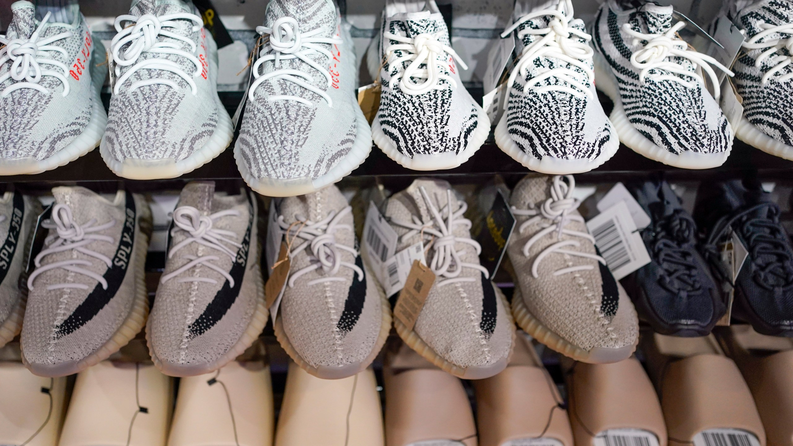 FILE - Yeezy shoes made by Adidas are displayed at Laced Up, a sneaker resale store, in Paramus, N.J., Tuesday, Oct. 25, 2022. Some of Adidas' remaining Yeezy shoes are back on sale, Wednesday, May 31, 2023, months after the German sportsware company cut ties with Ye, the rapper formerly known as Kanye West. (AP Photo/Seth Wenig)