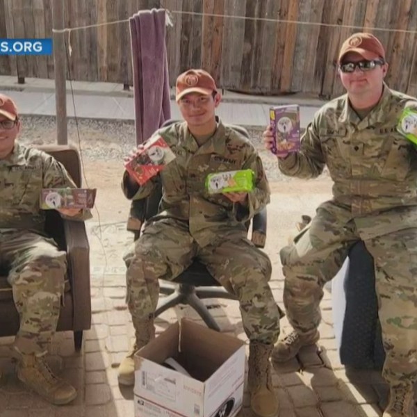 Soldiers with care package items - courtesy of Soldiers' Angels