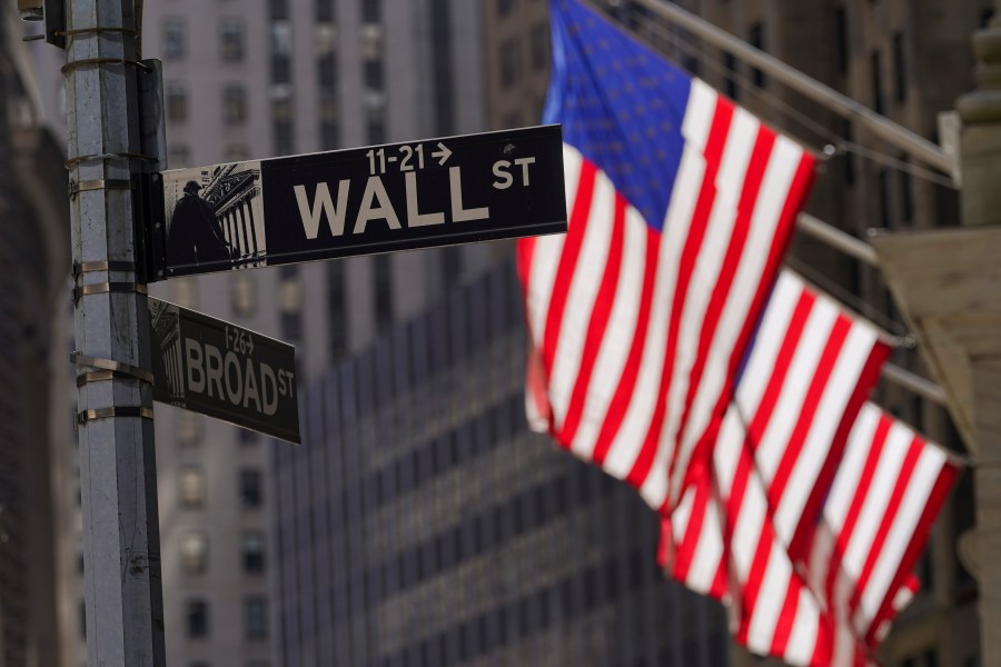 FILE - American flags fly outside the New York Stock Exchange, Friday, Sept. 23, 2022, in New York. The latest round of corporate earnings is leaving Wall Street with a confounding sense of relief and lingering anxiety. Companies are in the midst of an “earnings recession,” meaning profits have contracted for two straight quarters, starting with a 4.6% drop at the end of 2022. (AP Photo/Mary Altaffer, File)