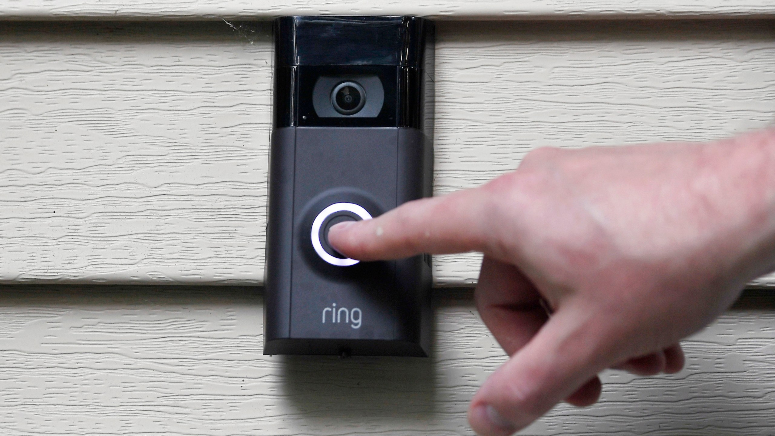 FILE - Ernie Field pushes the doorbell on his Ring doorbell camera, July 16, 2019, at his home in Wolcott, Conn. In a vote Wednesday, May 31, 2023, the Federal Trade Commission is ordering Amazon to pay more than $30 million in fines over privacy violations involving its voice assistant Alexa and its doorbell camera Ring. (AP Photo/Jessica Hill, File)