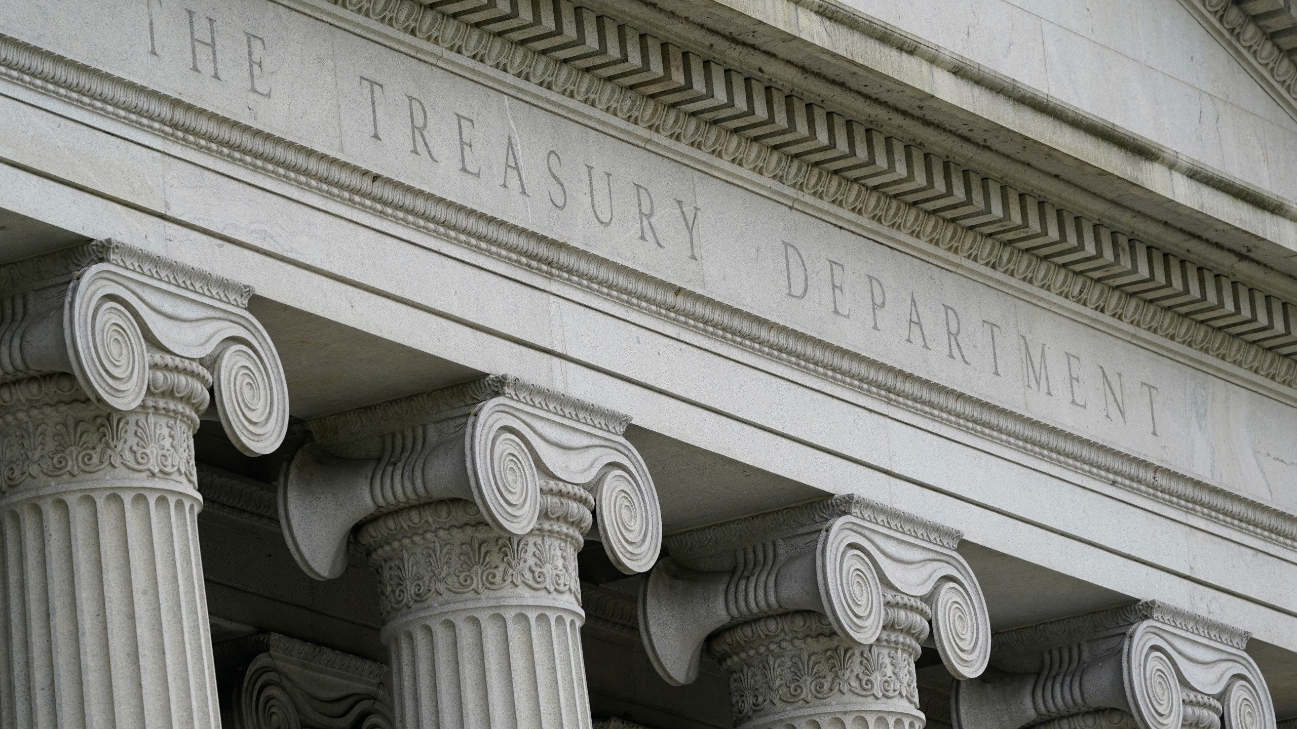 FILE - The Treasury Building is viewed in Washington, May 4, 2021. The United States has announced sanctions against a group of Iranian and Turkish people and firms accused of plotting to assassinate former U.S. government officials, dual U.S. and Iranian nationals, and dissidents. Several alleged assassination plots have been uncovered in recent years. (AP Photo/Patrick Semansky, File)