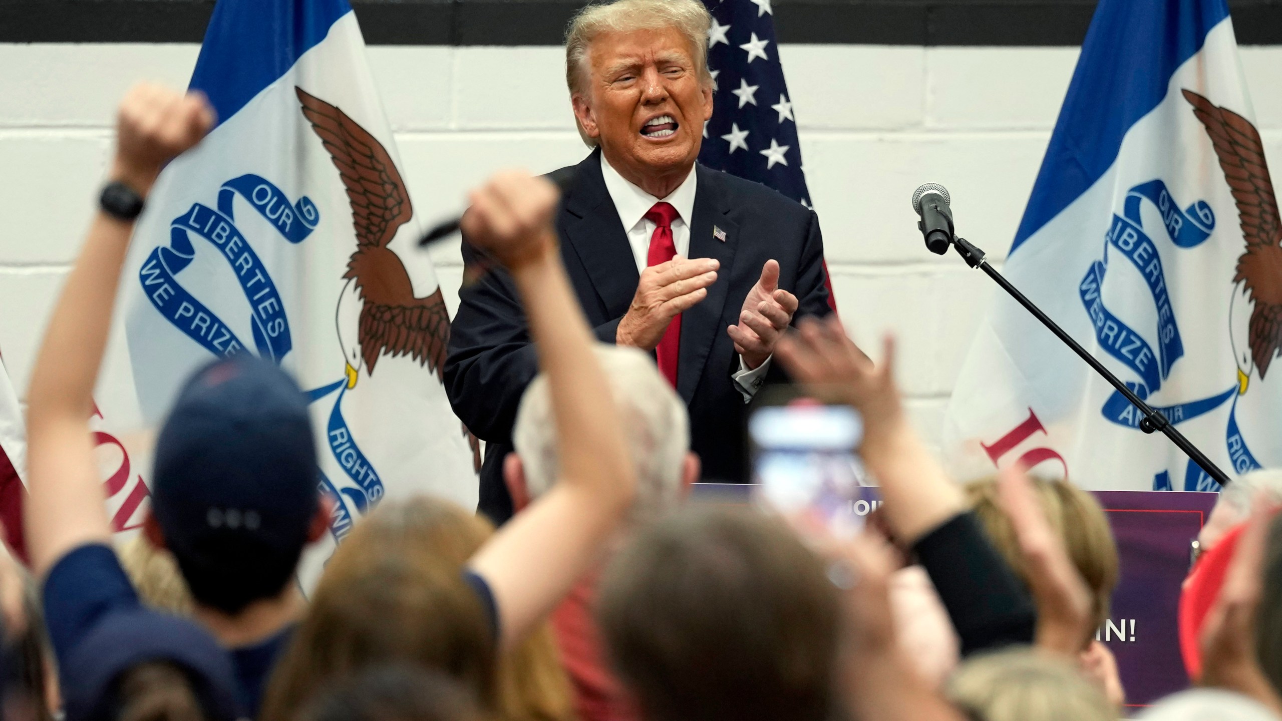 Former President Donald Trump reacts as he visits with campaign volunteers at the Grimes Community Complex Park, Thursday, June 1, 2023, in Des Moines, Iowa. (AP Photo/Charlie Neibergall)