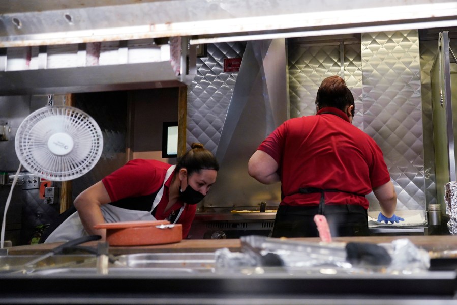 File - Women work in a restaurant kitchen in Chicago, Thursday, March 23, 2023. On Friday, the U.S. government issues the May jobs report. The labor market has added jobs at a steady clip in the past year, despite efforts by the Federal Reserve to cool the economy and bring down inflation. (AP Photo/Nam Y. Huh, File)