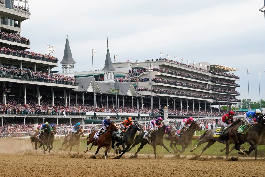 FILE - Javier Castellano, atop Mage, third from left, is seen behind with others behind the pack as they make the first turn while competing in the 149th running of the Kentucky Derby horse race at Churchill Downs Saturday, May 6, 2023, in Louisville, Ky. Churchill Downs will limit horses to four starts during a rolling eight-week period and impose ineligibility standards for continued poor performance in the wake of the recent deaths of 12 horses at the home of the Kentucky Derby. (AP Photo/Julio Cortez, File)